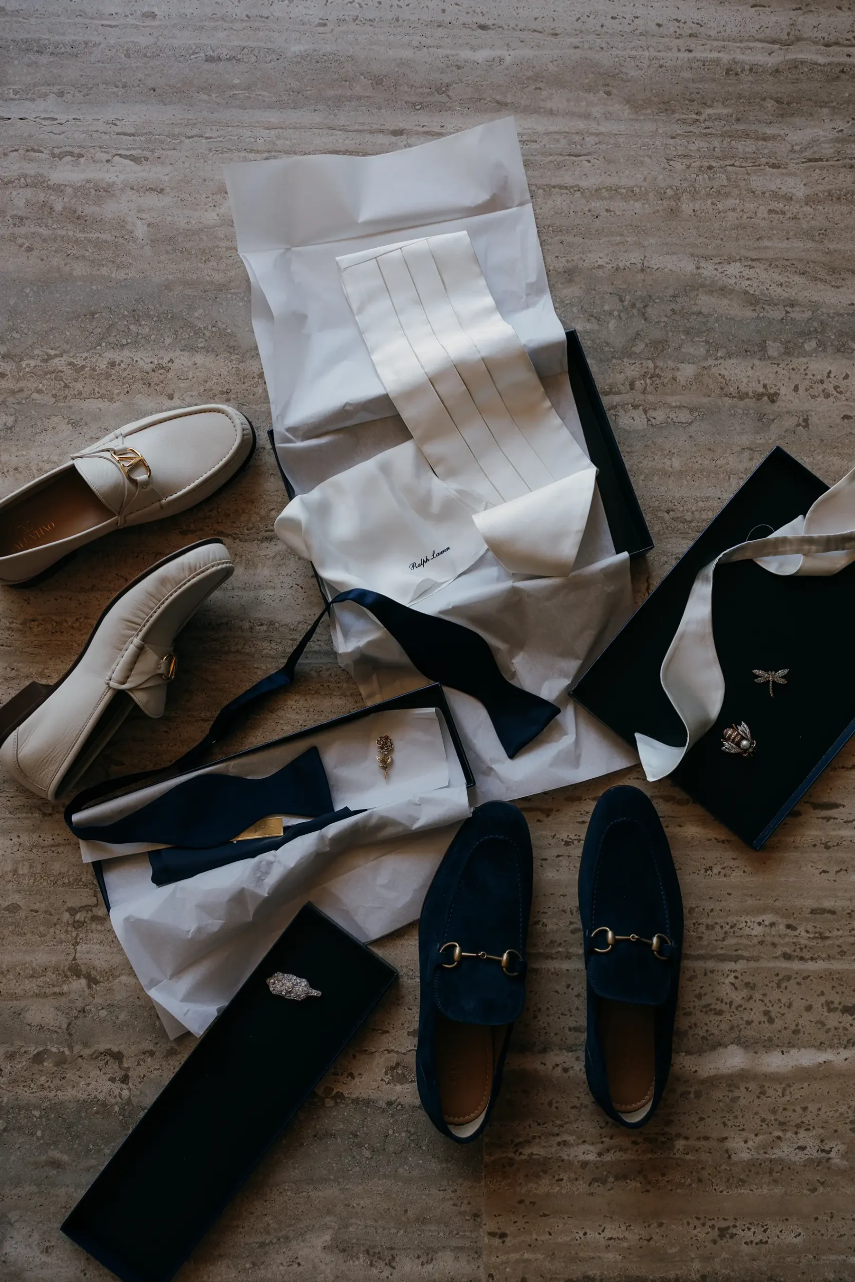 Flat lay of wedding bow ties and dress shoes from Valentino and Gucci for Four Seasons Tamarindo wedding in Mexico