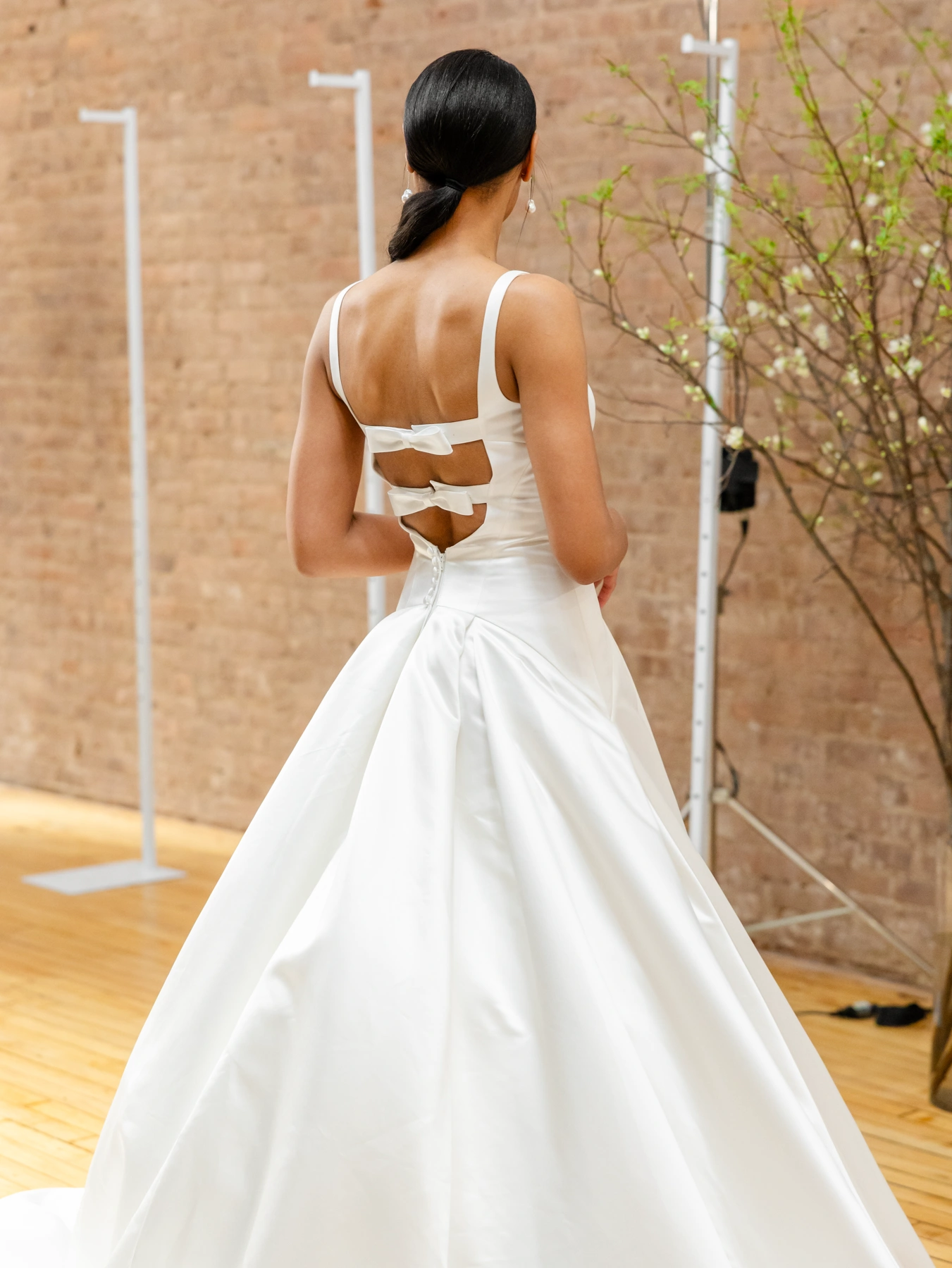 back of wedding gown with two bow straps