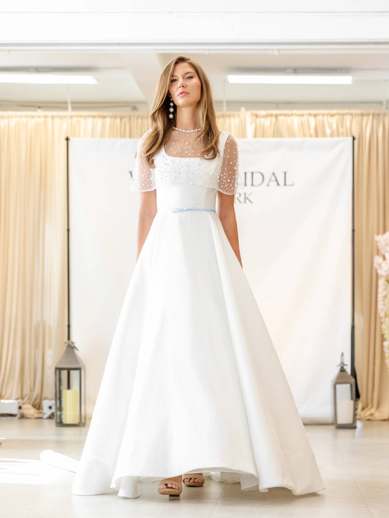 Verdin wedding gown with thin blue ribbon at waist