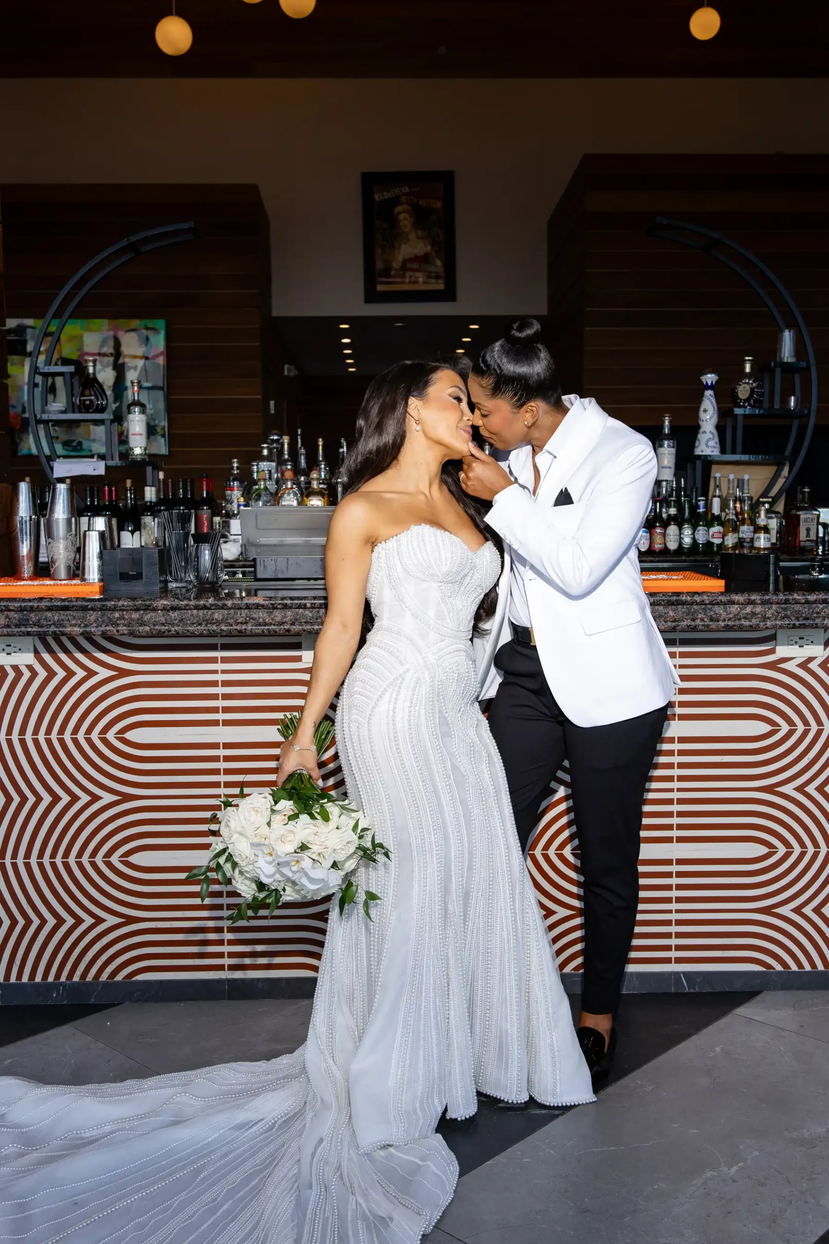 Katherine and Michelle share a tender kiss at the bar inside Hudson House in Jersey City, N.J., on their wedding day.