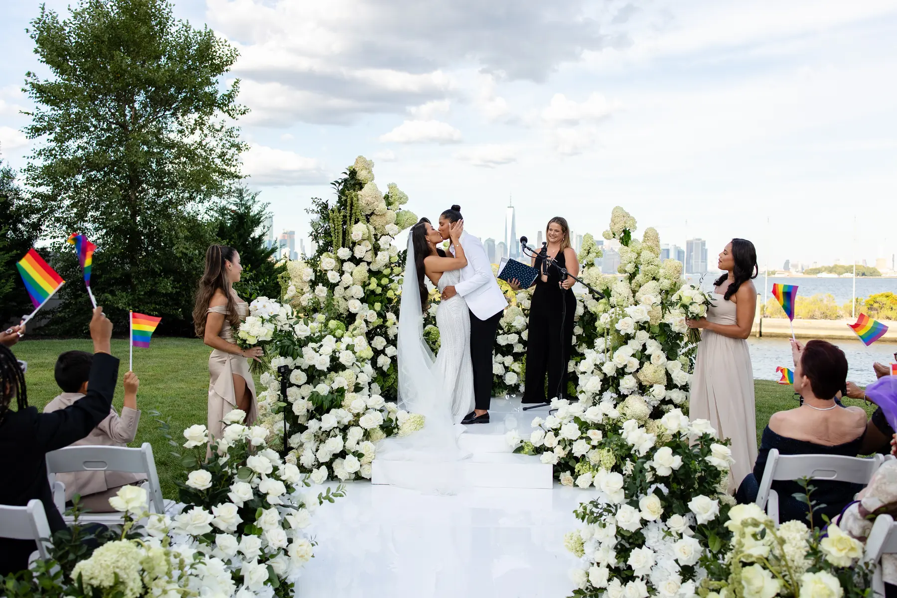 Katherine and Michelle share their first kiss at the altar during their outdoor wedding ceremony at Hudson House in Jersey City, N.J.