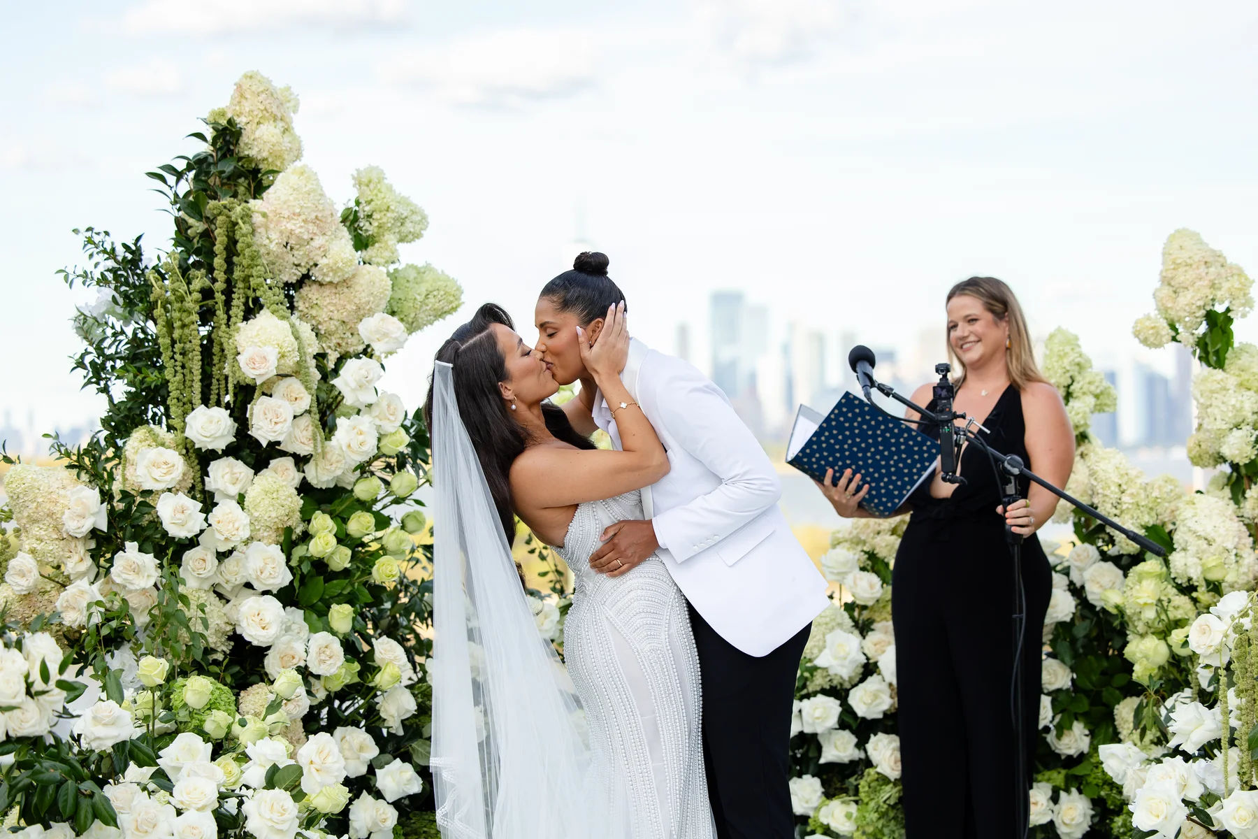Katherine and Michelle share their first kiss as a married couple at Hudson House in Jersey City, N.J., surrounded by white roses.