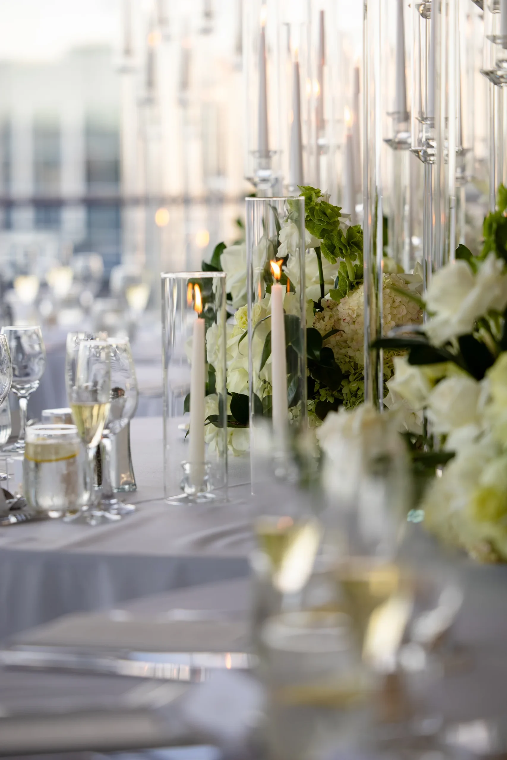 Elegant reception table at Hudson House with tall crystal candelabras, white hydrangeas and tapered candles for Katherine and Michelle.