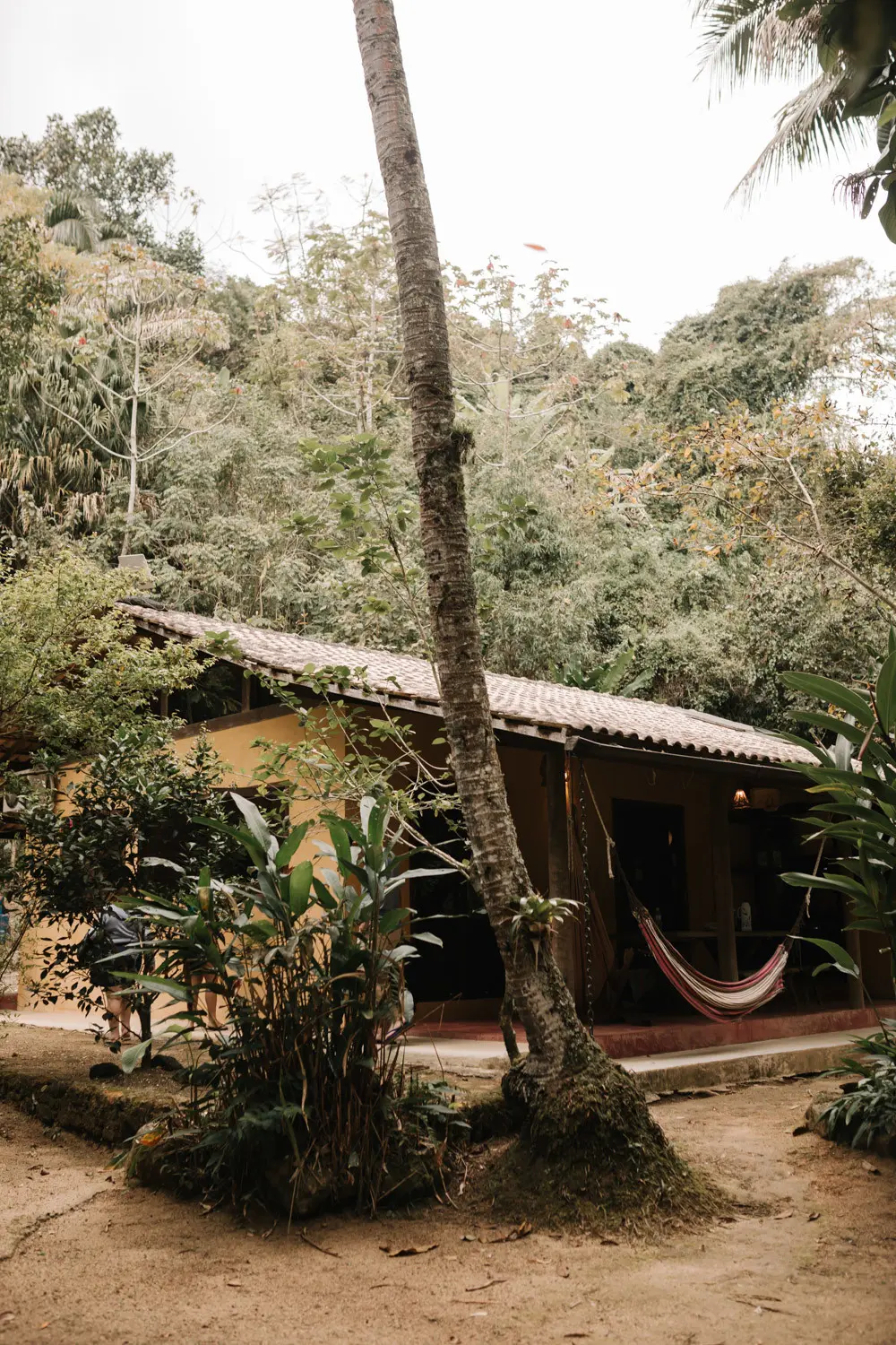 Lush tropical venue at Pouso das Flores in Paraty, Brazil, with a hammock and palm trees for Rafaela and Nathalia's wedding.