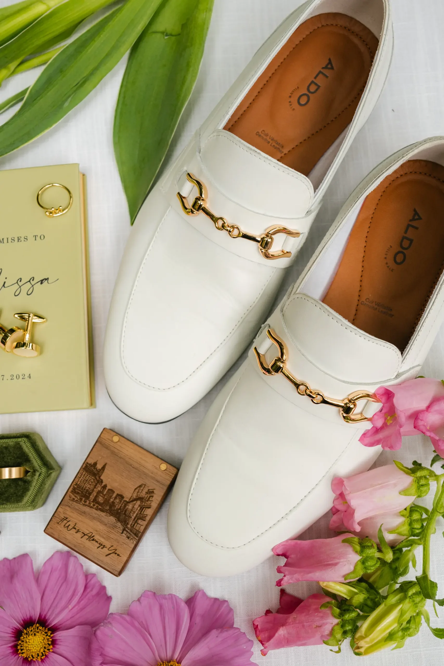 White ALDO loafers with gold horse bit detail styled with wedding accessories for Erika and Melissa's Botanica wedding.
