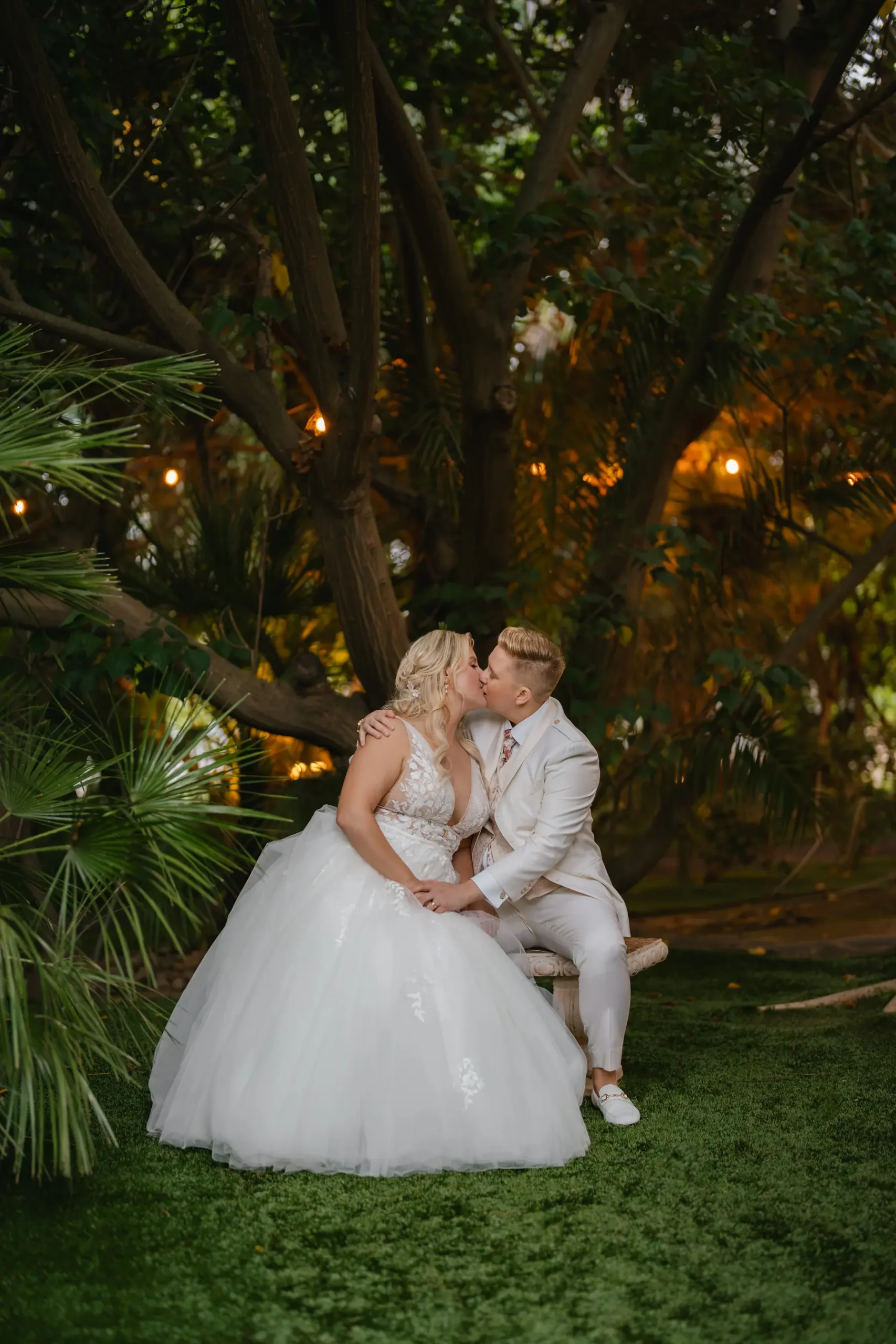 Erika Beursken and Melissa Brodsky share a kiss on a bench at Botanica in Oceanside, California.