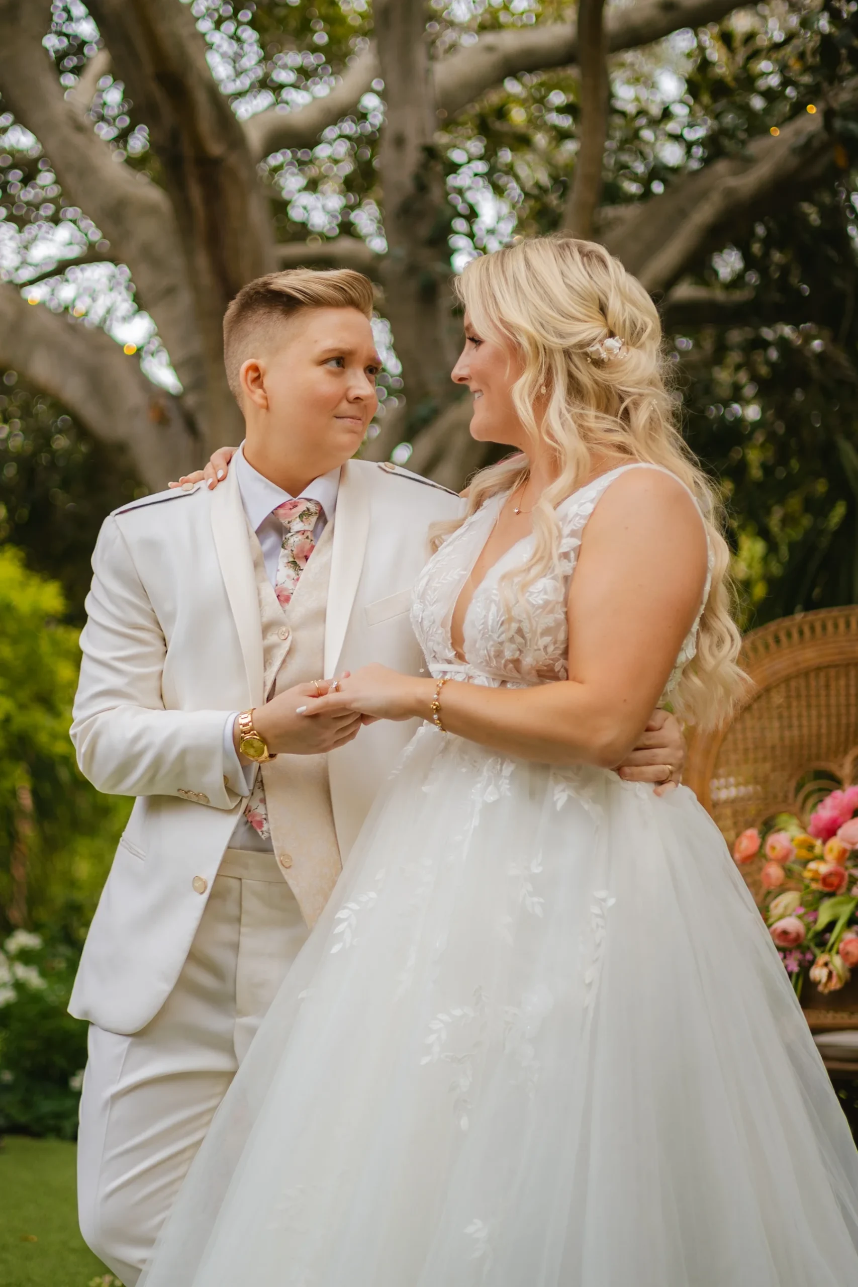 Erika Beursken and Melissa Brodsky hold hands and gaze at each other at Botanica in Oceanside, California.