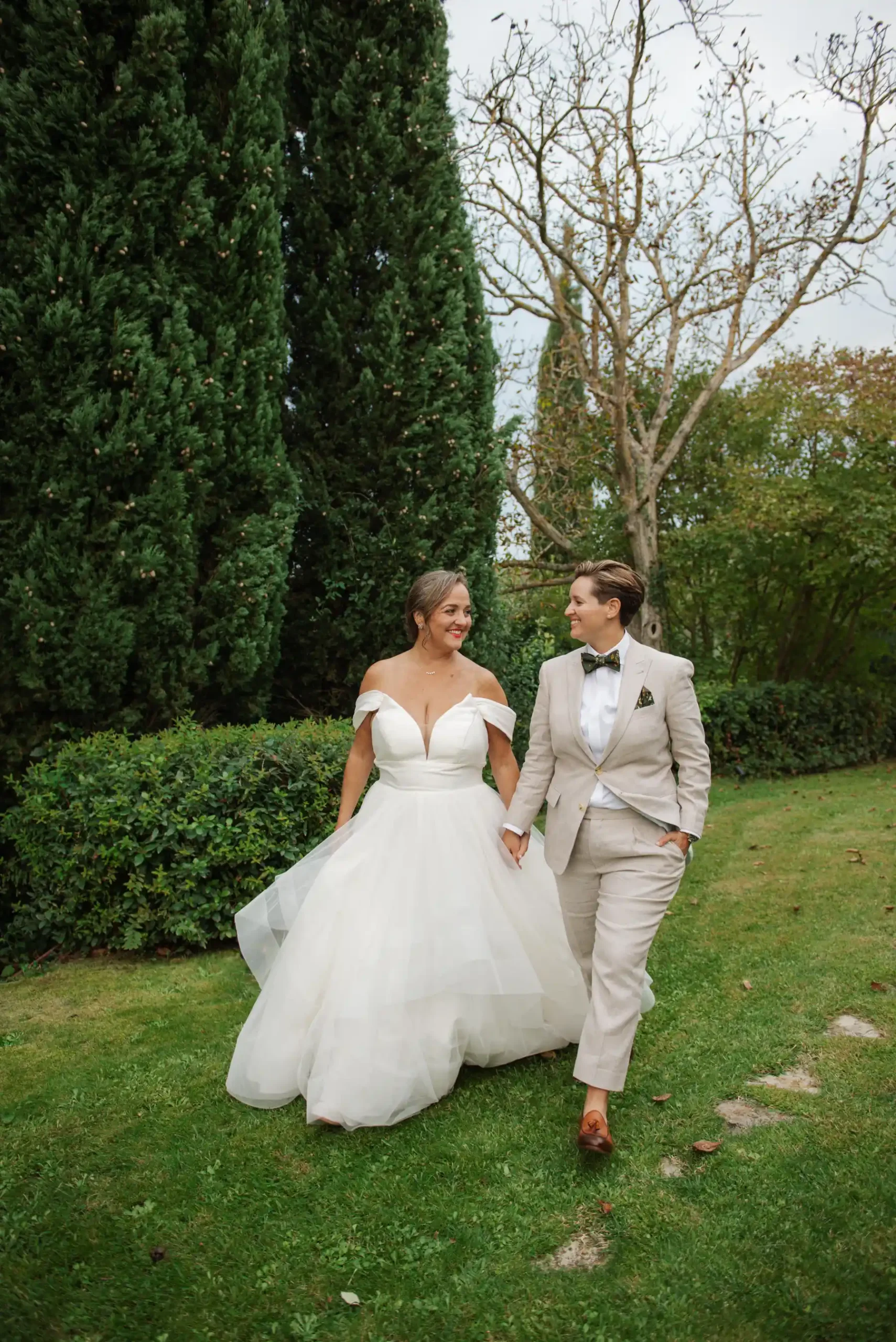 Lauren Thomas and Jasmine Shimerda walk hand in hand through the gardens at Casa Cornacchi in Arezzo, Tuscany.