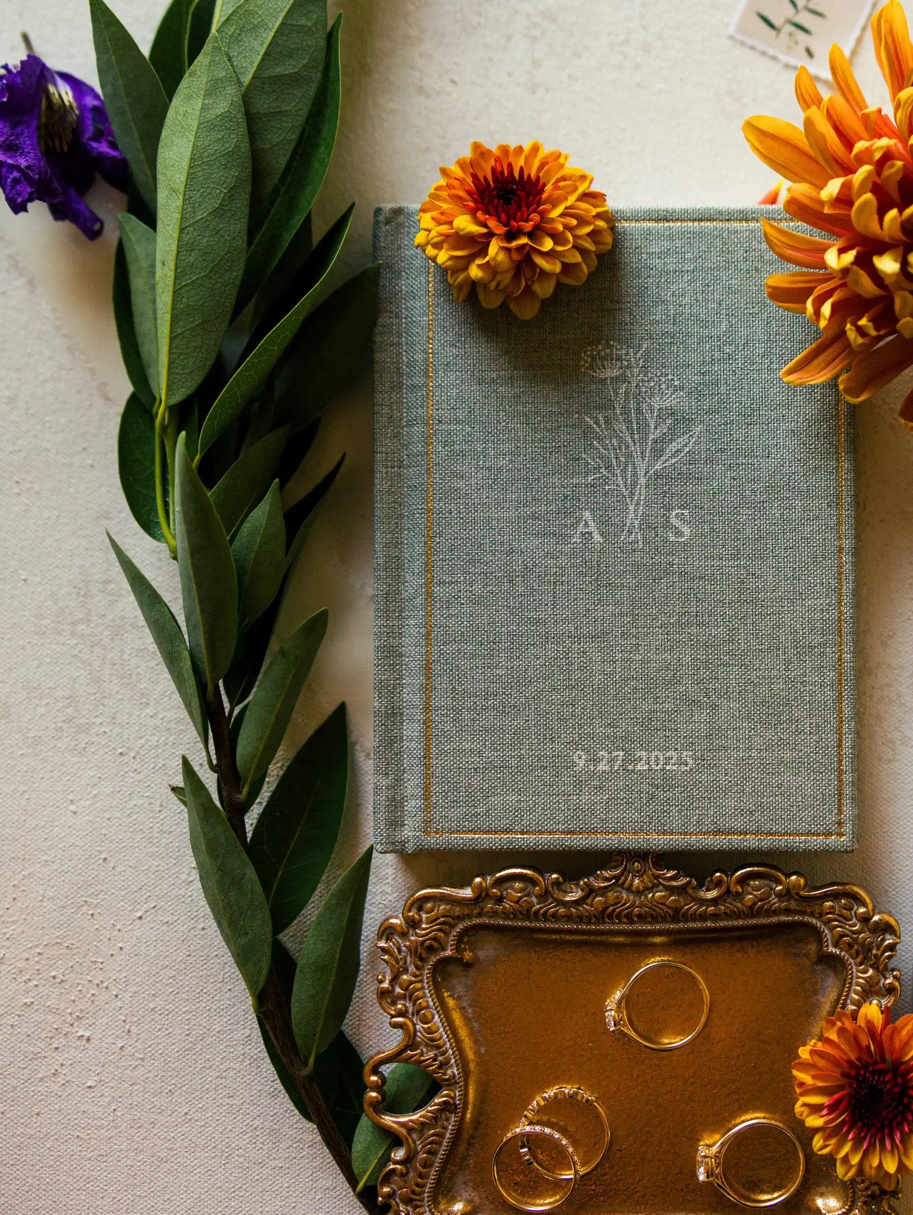 Sage linen wedding vow book monogrammed A&S dated 9.27.2023, gold rings, orange flowers at Hampshire House Boston