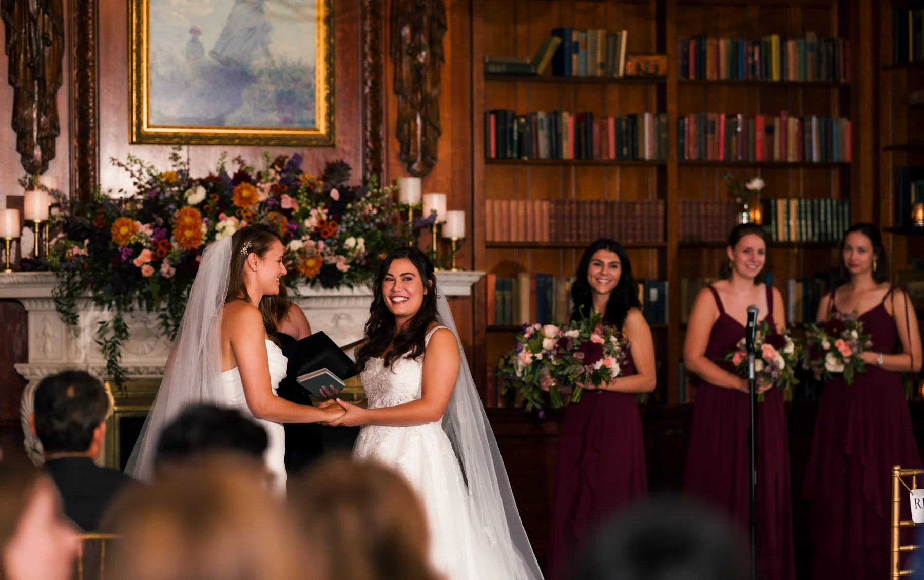 Brides Ashton Hattori and Stephanie Tillman exchange vows while holding hands at Hampshire House in Boston.