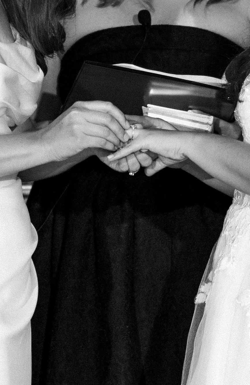 Ashton Hattori and Stephanie Tillman exchange rings during their wedding ceremony at Hampshire House in Boston.