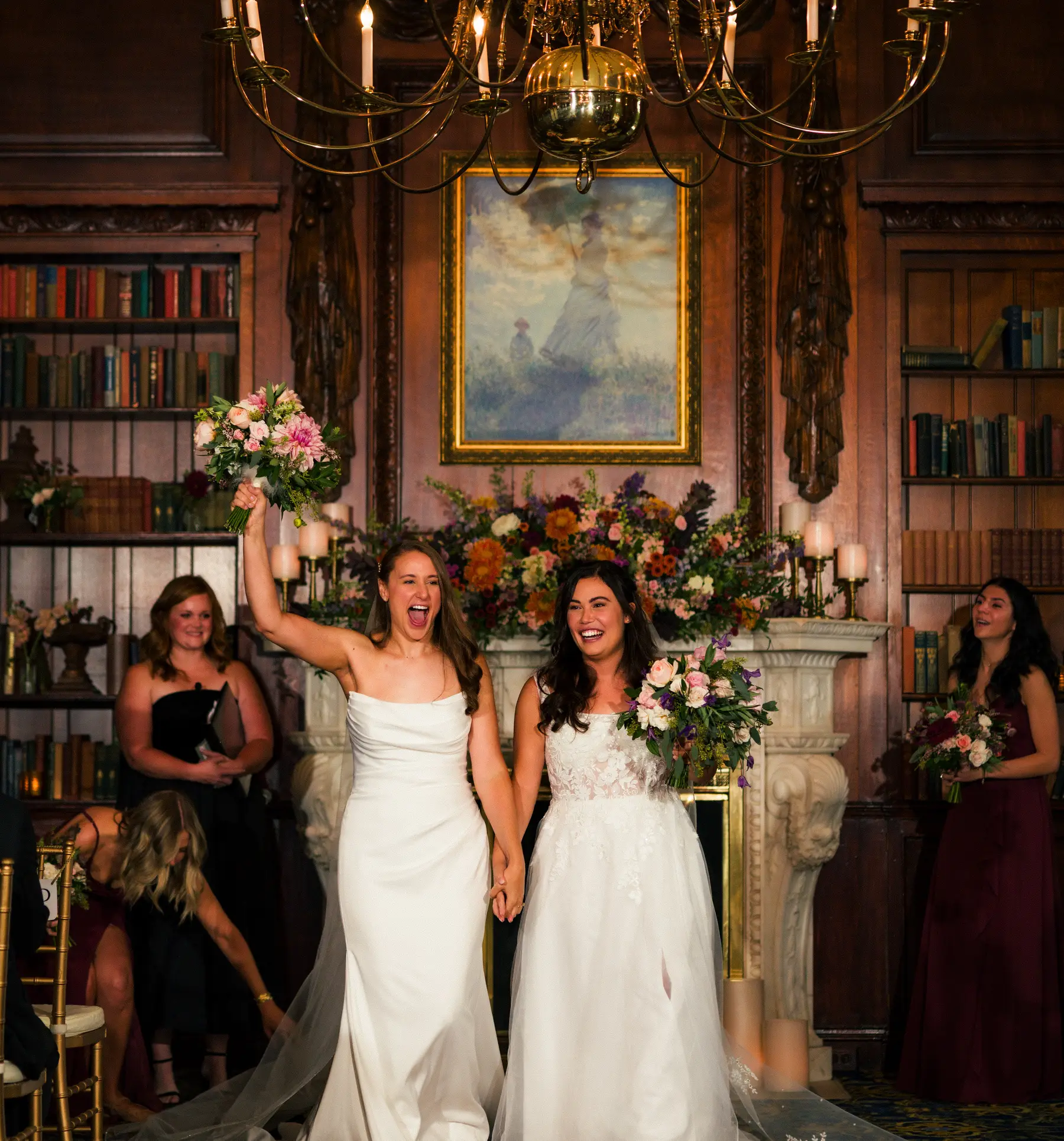 Brides Ashton Hattori and Stephanie Tillman celebrate after their ceremony at Hampshire House in Boston, raising bouquets.
