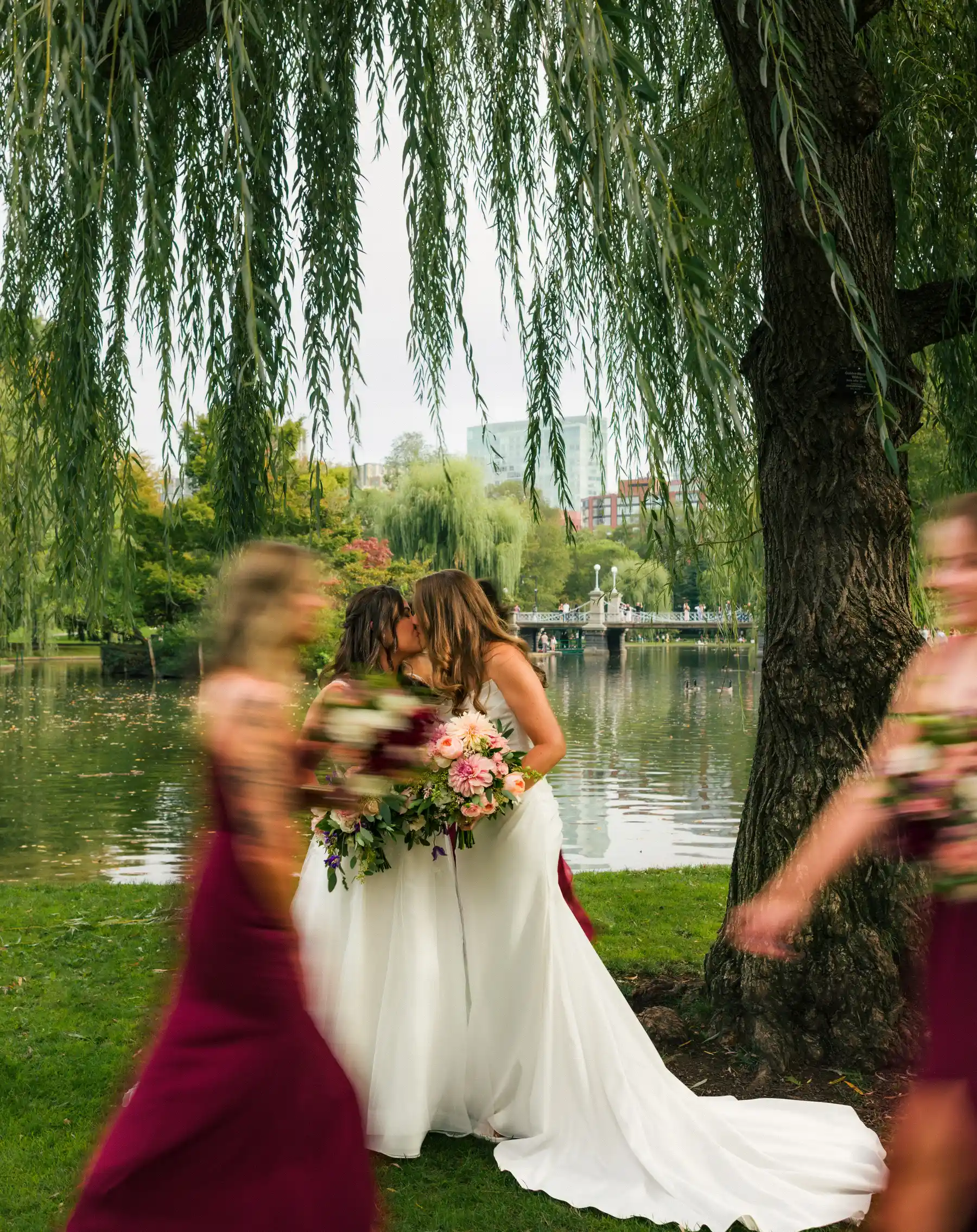 Brides Ashton Hattori and Stephanie Tillman share a kiss under a weeping willow at Boston Public Garden.