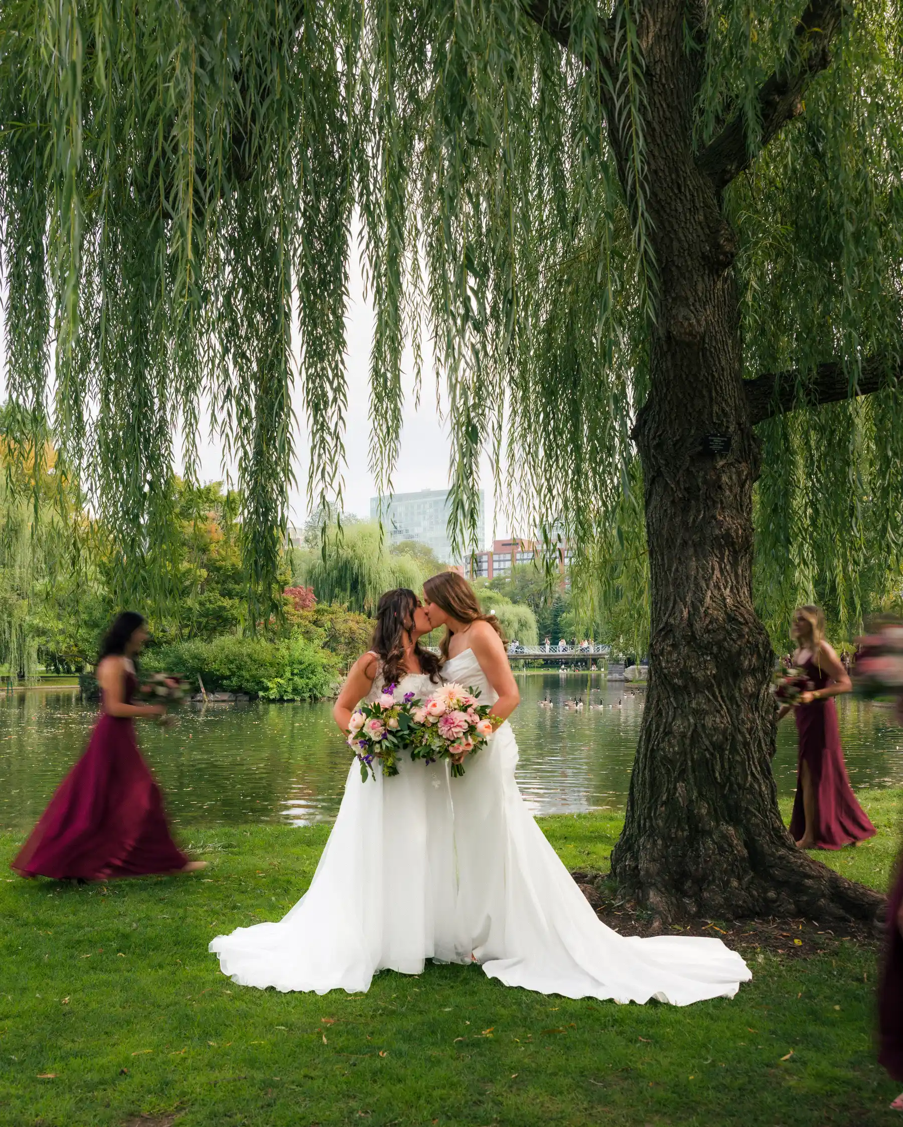 Brides Ashton Hattori and Stephanie Tillman share a kiss under a weeping willow at Boston Public Garden.