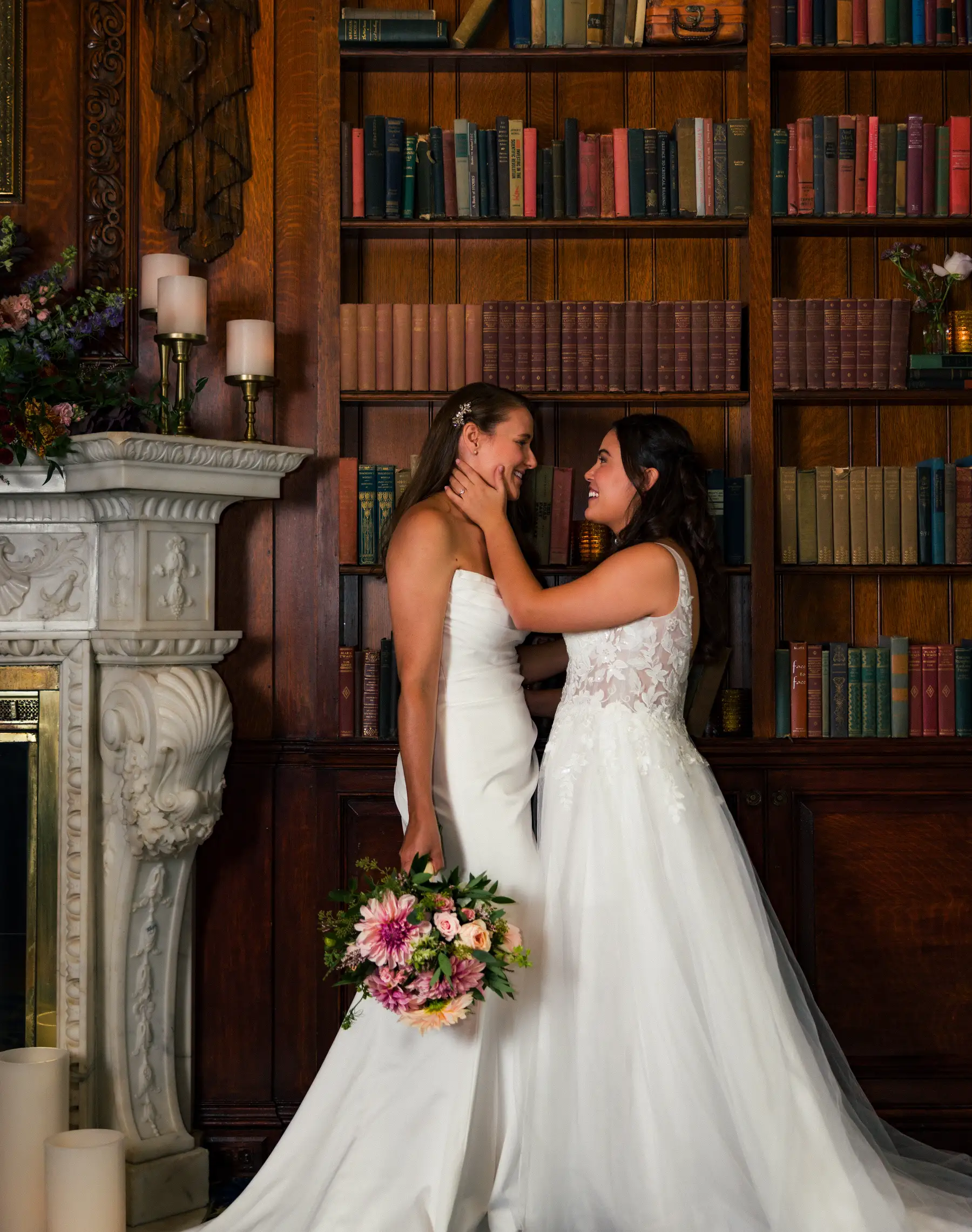 Brides Ashton Hattori and Stephanie Tillman share a joyful moment in the library at Hampshire House in Boston.
