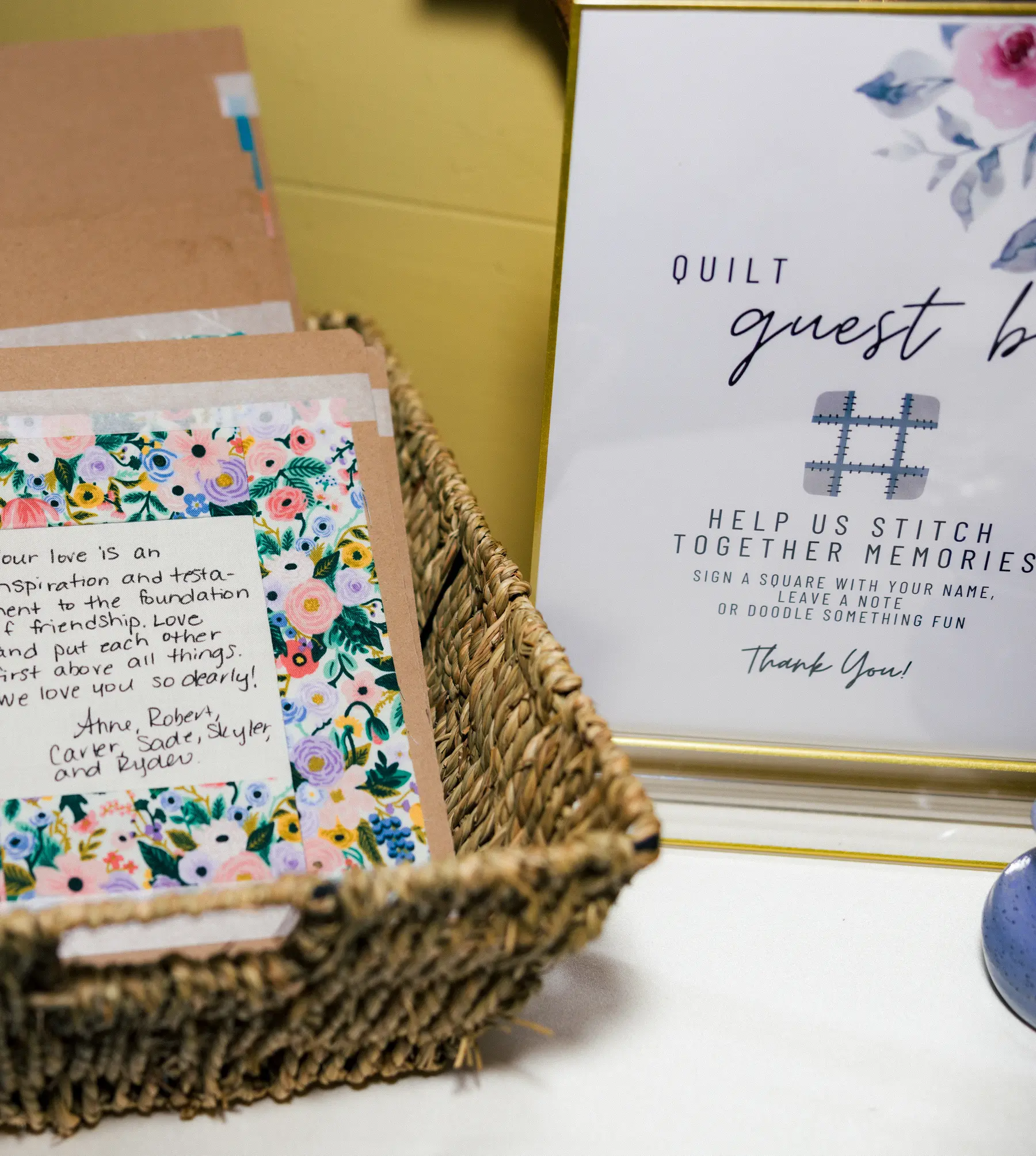 Quilt guest book station with floral fabric squares and handwritten notes at Ashton and Stephanie's Hampshire House wedding.