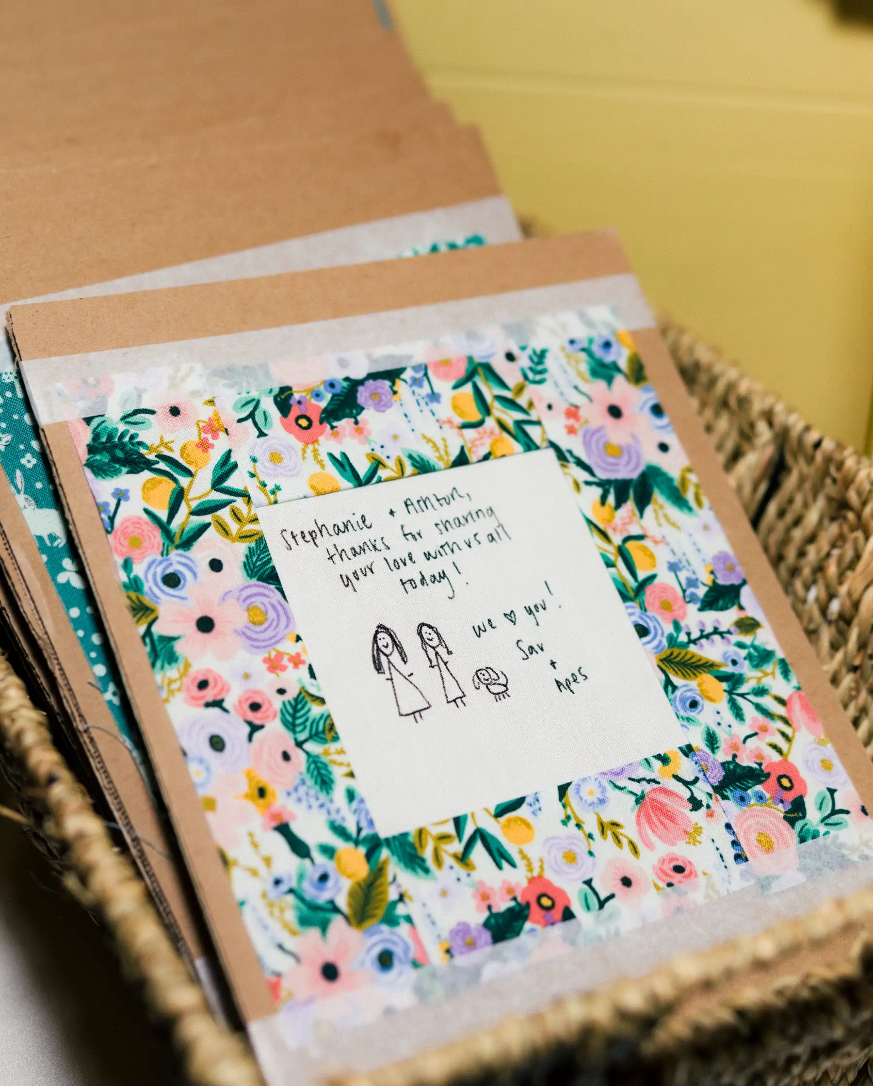 A floral wedding card addressed to Stephanie and Ashton at their Hampshire House wedding in Boston.