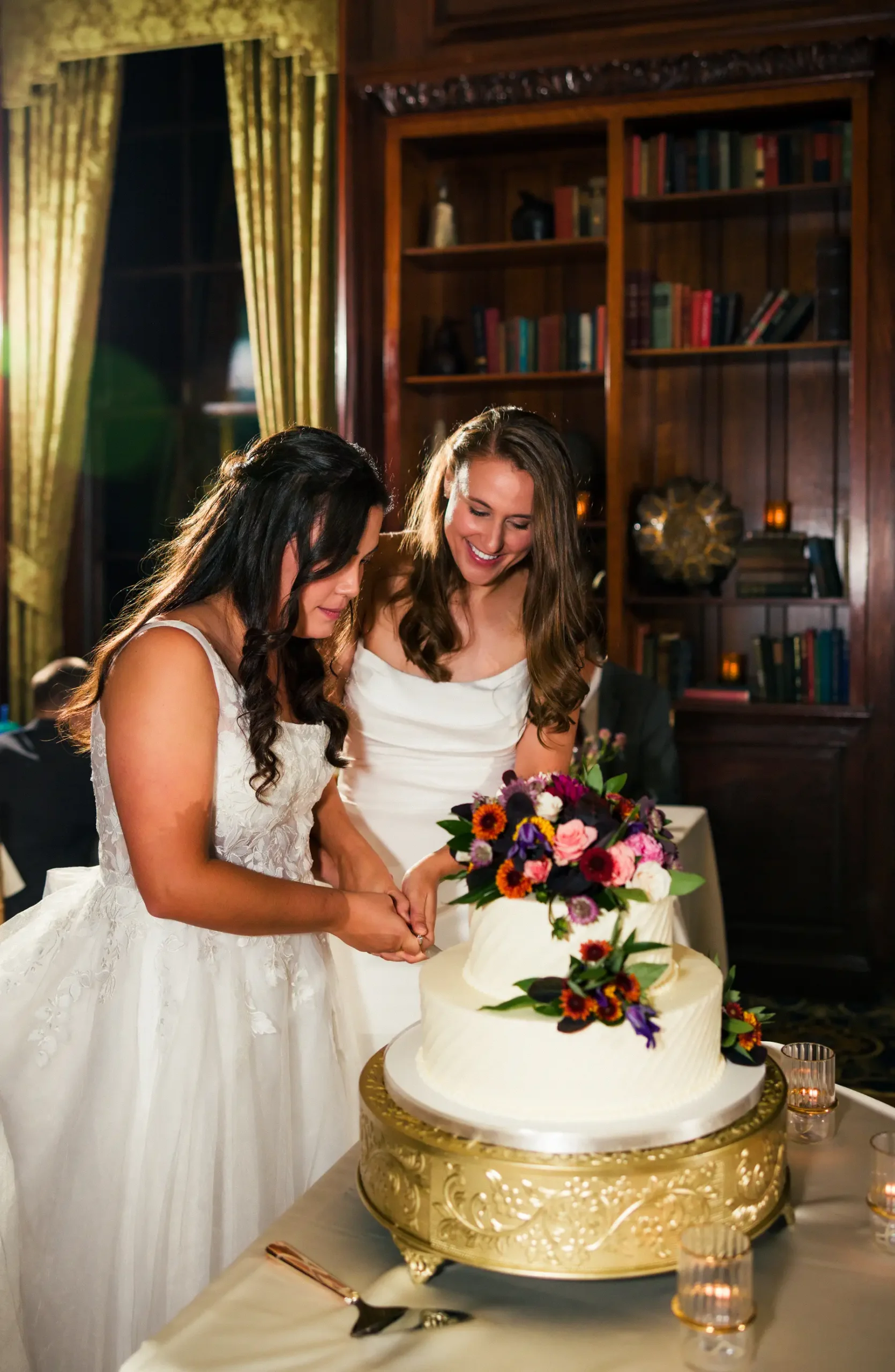 Ashton Hattori and Stephanie Tillman cut their two-tier white wedding cake at Hampshire House in Boston, MA.