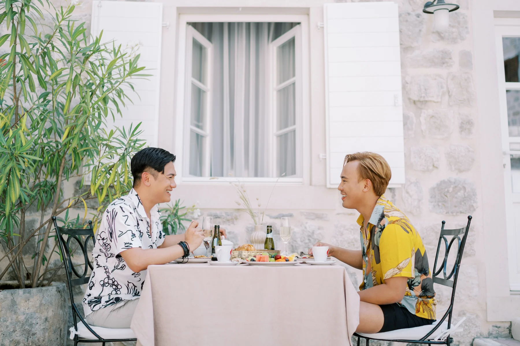 Ryan Jake Pisueña and Jori Blas Lazalita share a joyful outdoor lunch at Monte Bay Retreat in Perast, Montenegro.