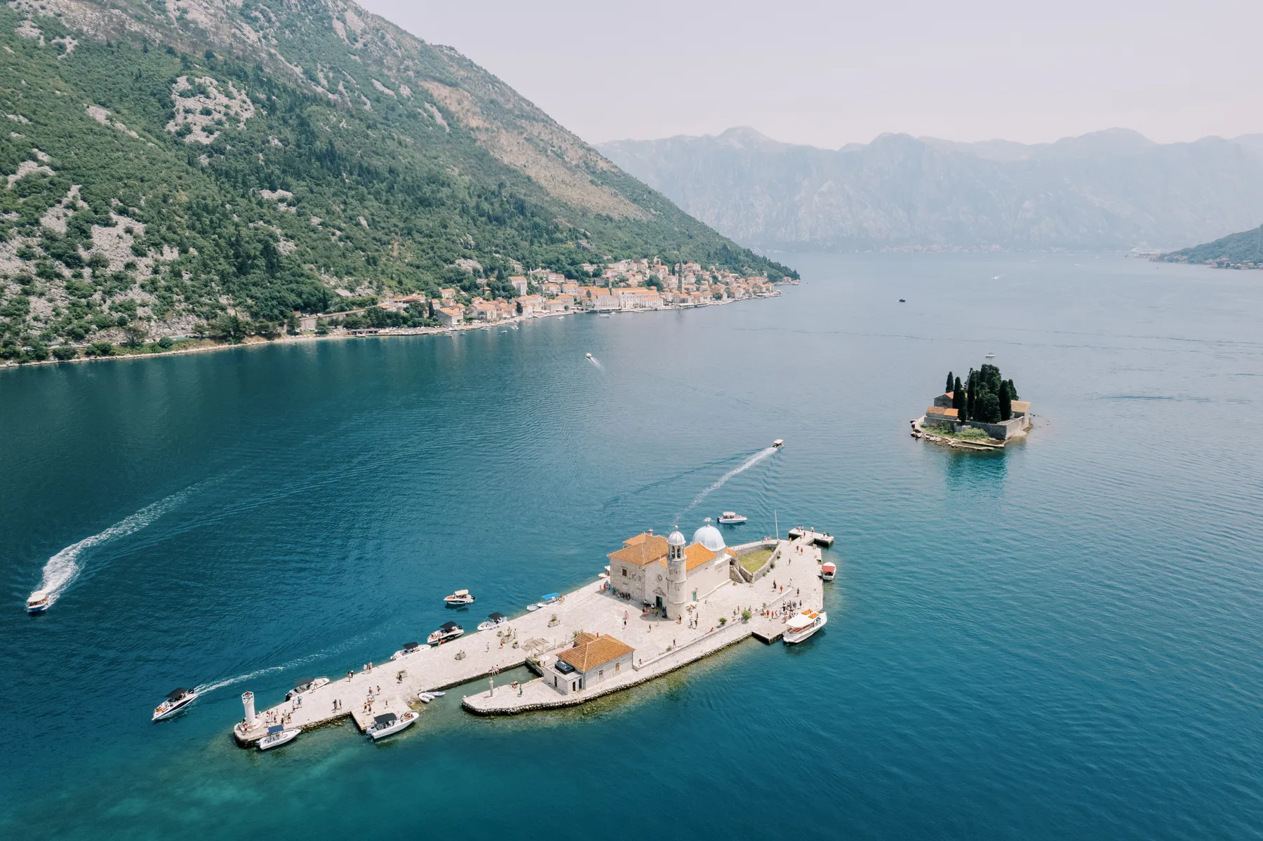 Aerial view of Our Lady of the Rocks island church in Perast, Montenegro, near Monte Bay Retreat.