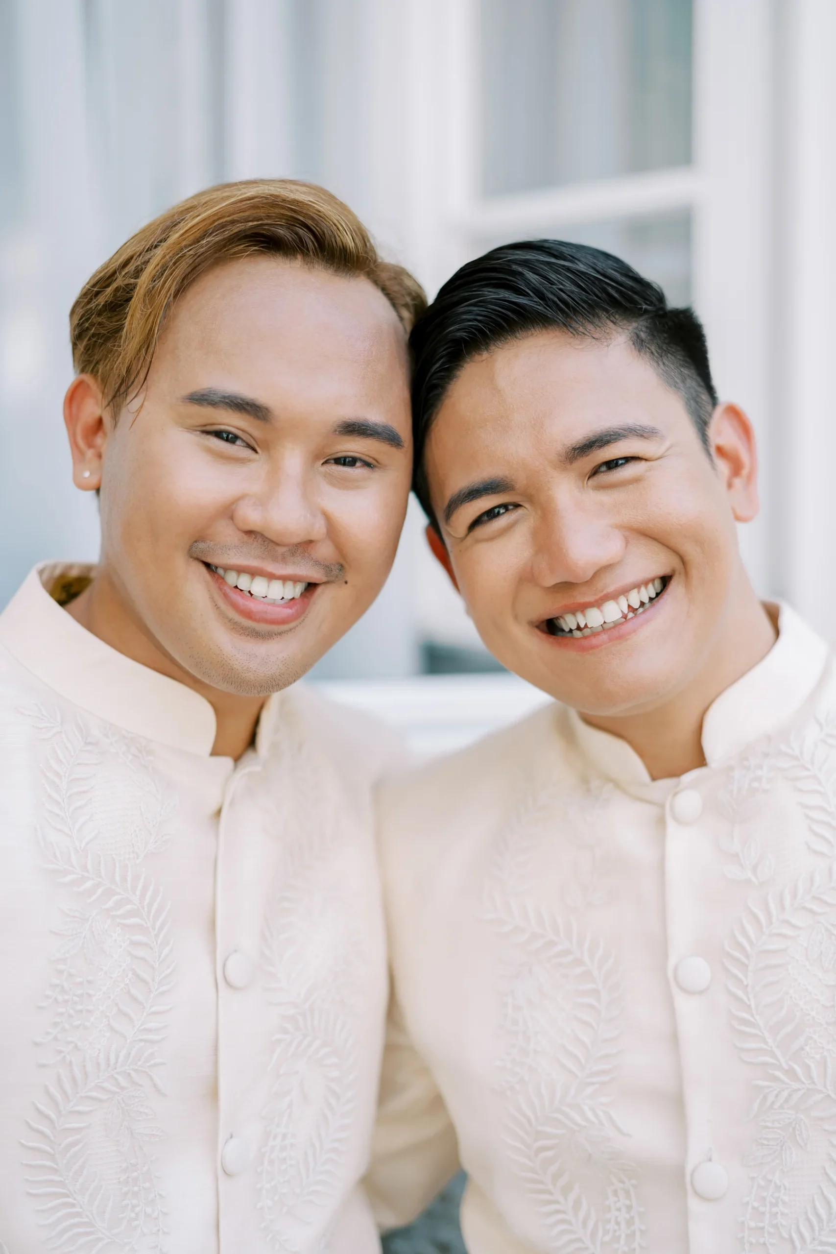 Ryan Jake Pisueña and Jori Blas Lazalita smile cheek to cheek in matching ivory barong tagalog at Monte Bay Retreat.