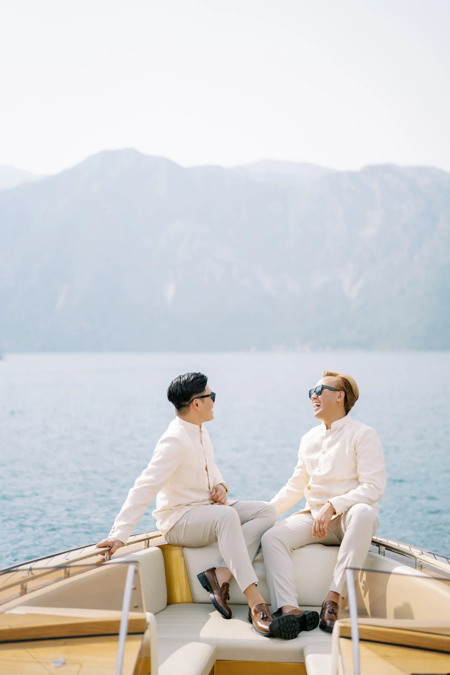 Ryan Jake Pisueña and Jori Blas Lazalita laugh together on a luxury boat on the Bay of Kotor, Montenegro.