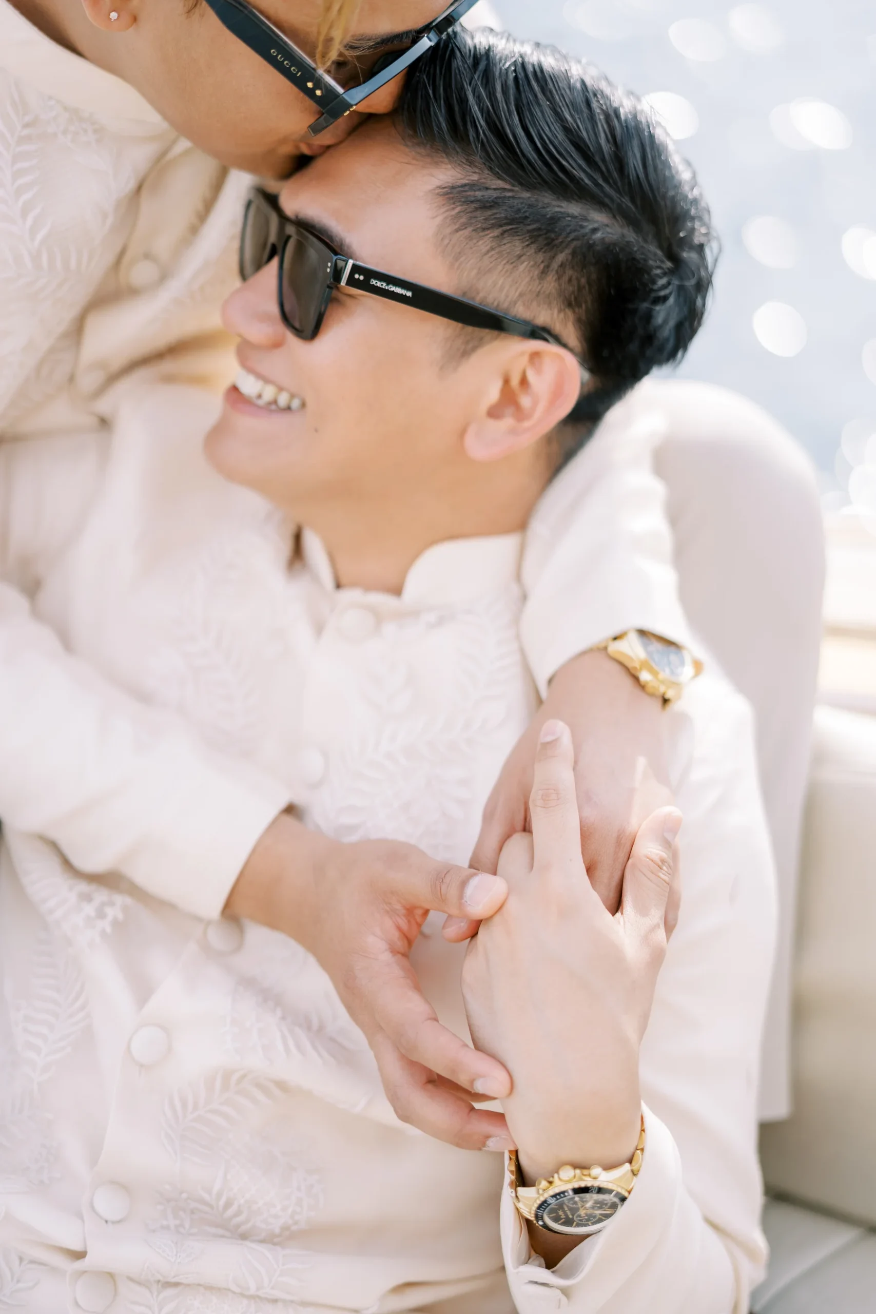 Ryan Jake and Jori share a tender embrace in cream embroidered outfits at Monte Bay Retreat in Perast, Montenegro.