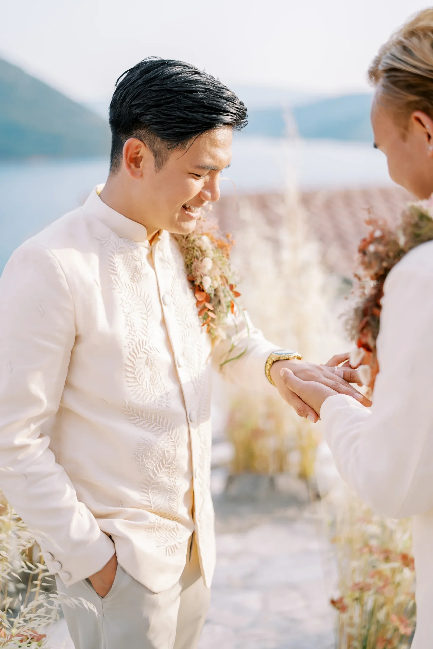 Ryan Jake Pisueña laughs joyfully as a ring is placed on his finger during his wedding ceremony at Monte Bay Retreat in Perast, Montenegro.