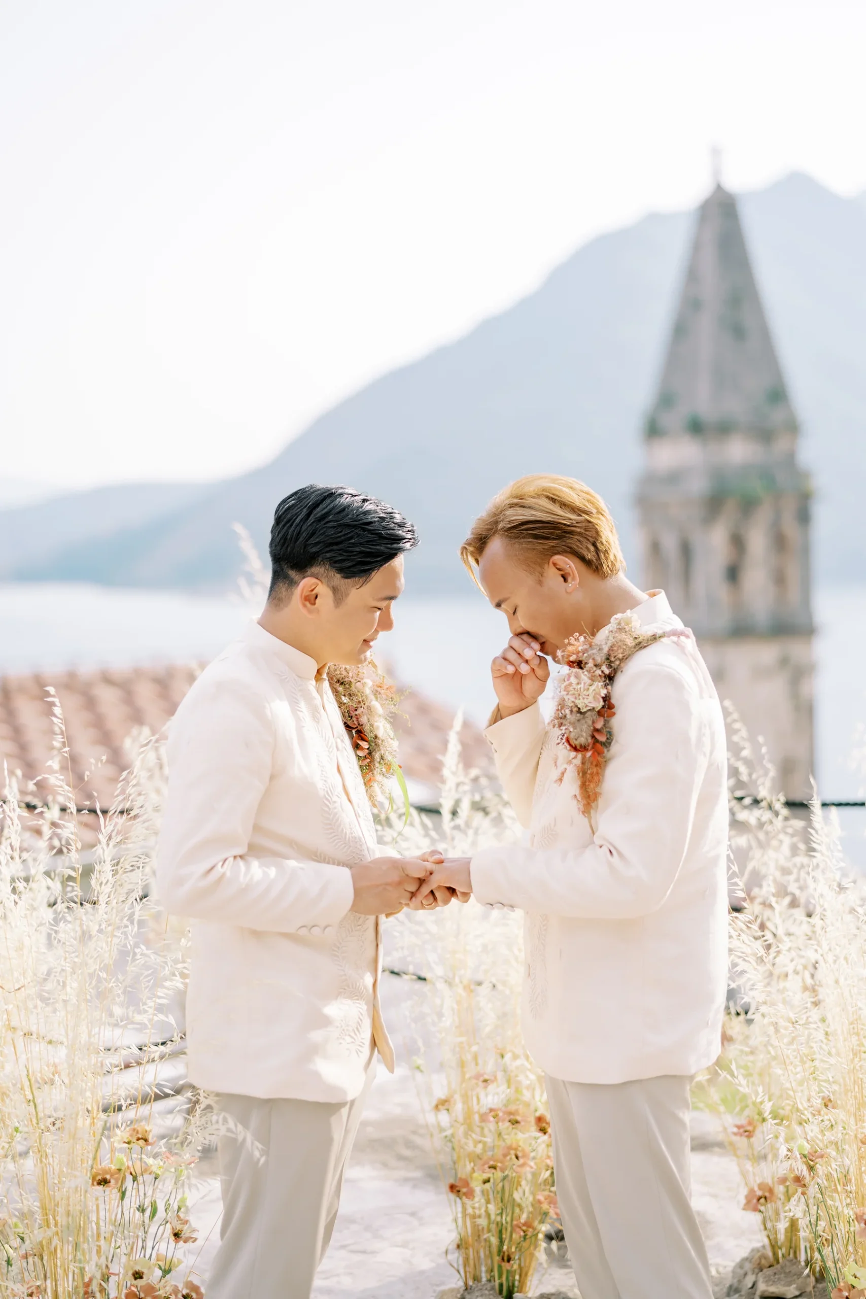 Ryan Jake Pisueña and Jori Blas Lazalita hold hands during their wedding ceremony at Monte Bay Retreat in Perast, Montenegro.