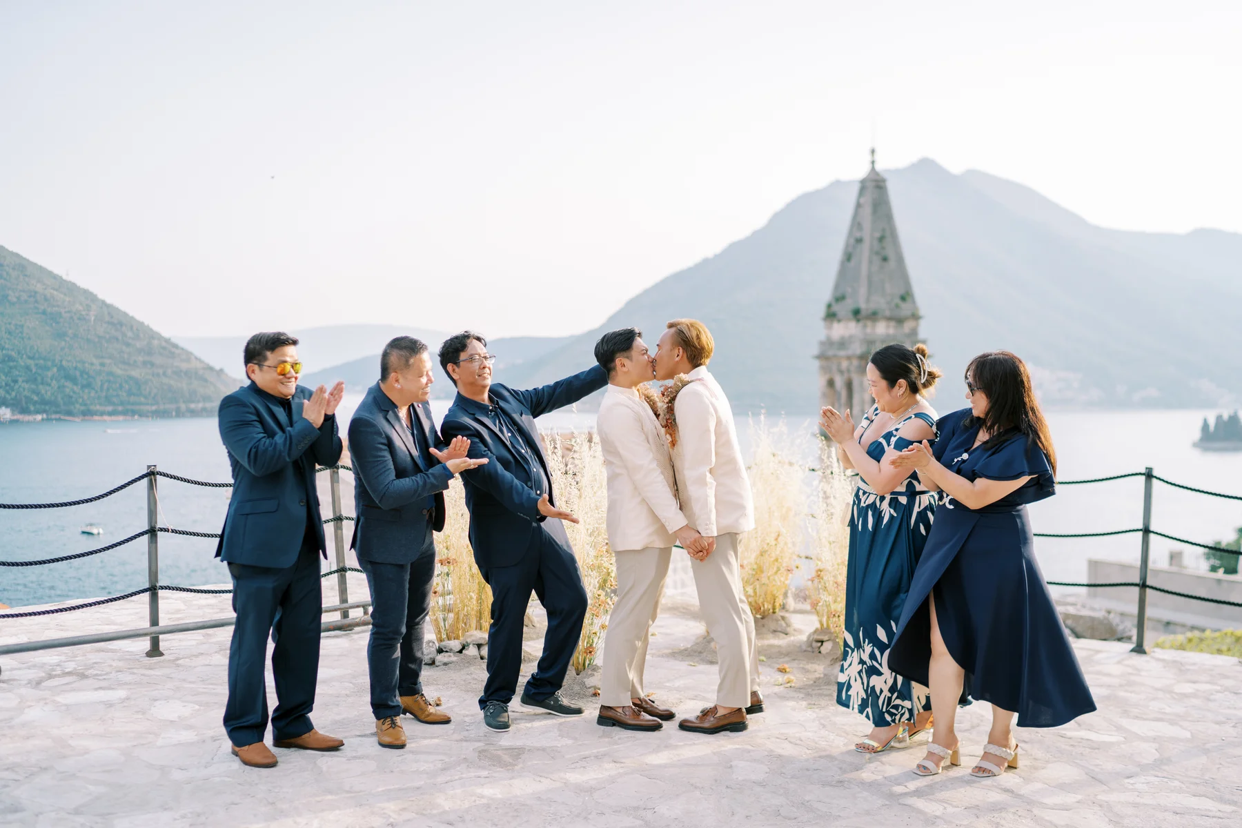 Ryan Jake and Jori share a first kiss as guests cheer at Monte Bay Retreat in Perast, Montenegro.