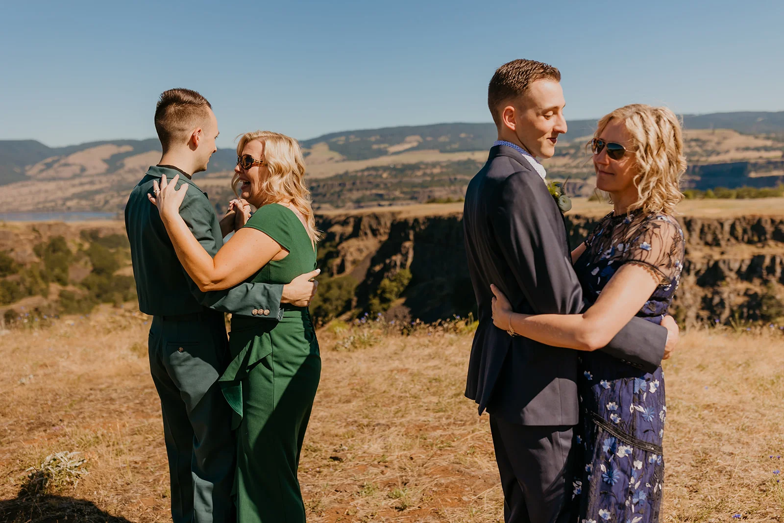 Ben and Nolan share embraces with their mothers at Mayer State Park in Mosier, OR, during their wedding.