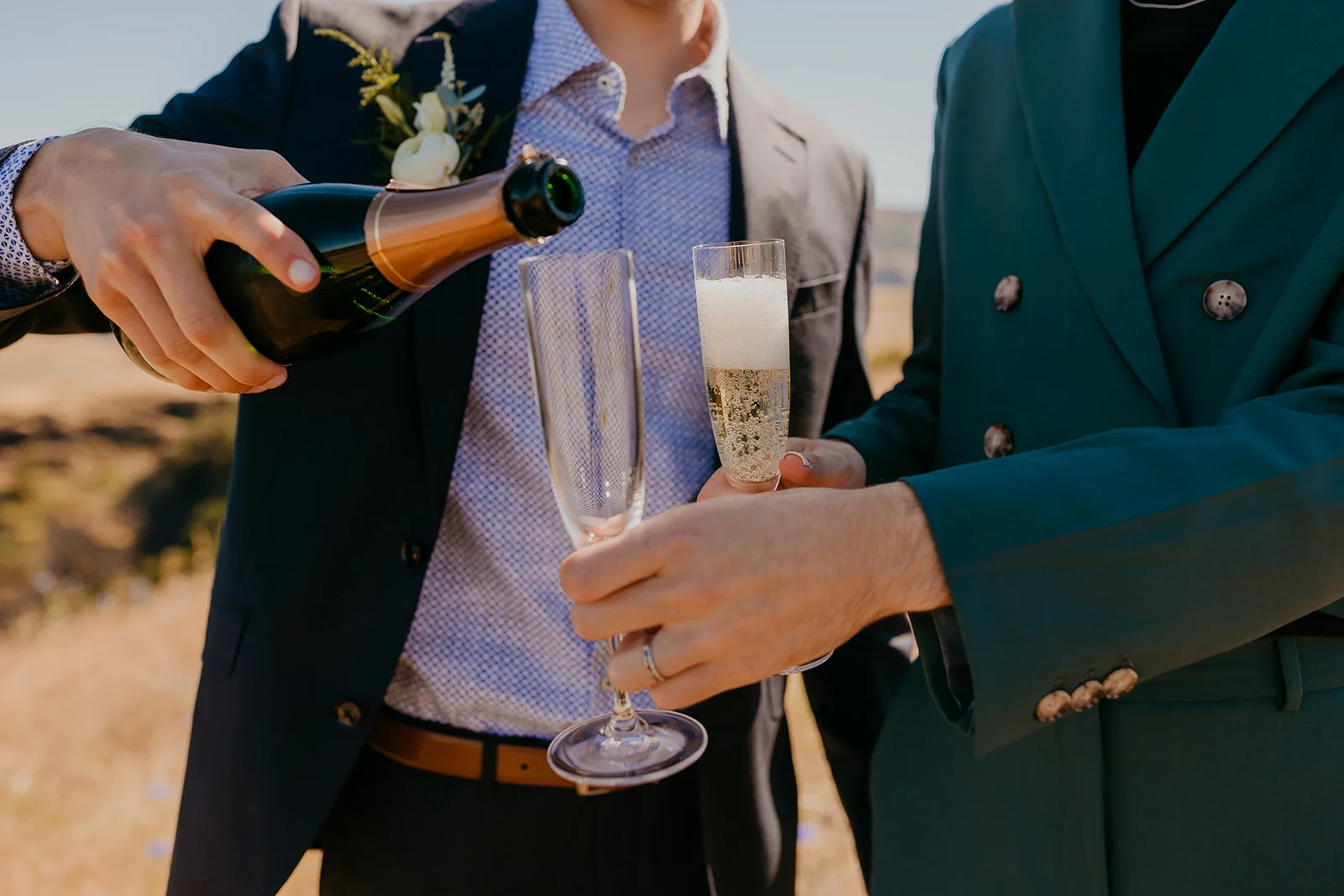 Ben and Nolan's champagne toast at Mayer State Park in Mosier, OR, with bubbly being poured into flutes.