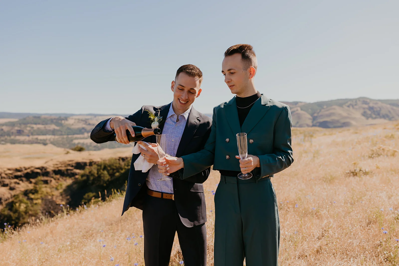 Ben and Nolan share a champagne toast outdoors at NA Mayer State Park in Mosier, Oregon.