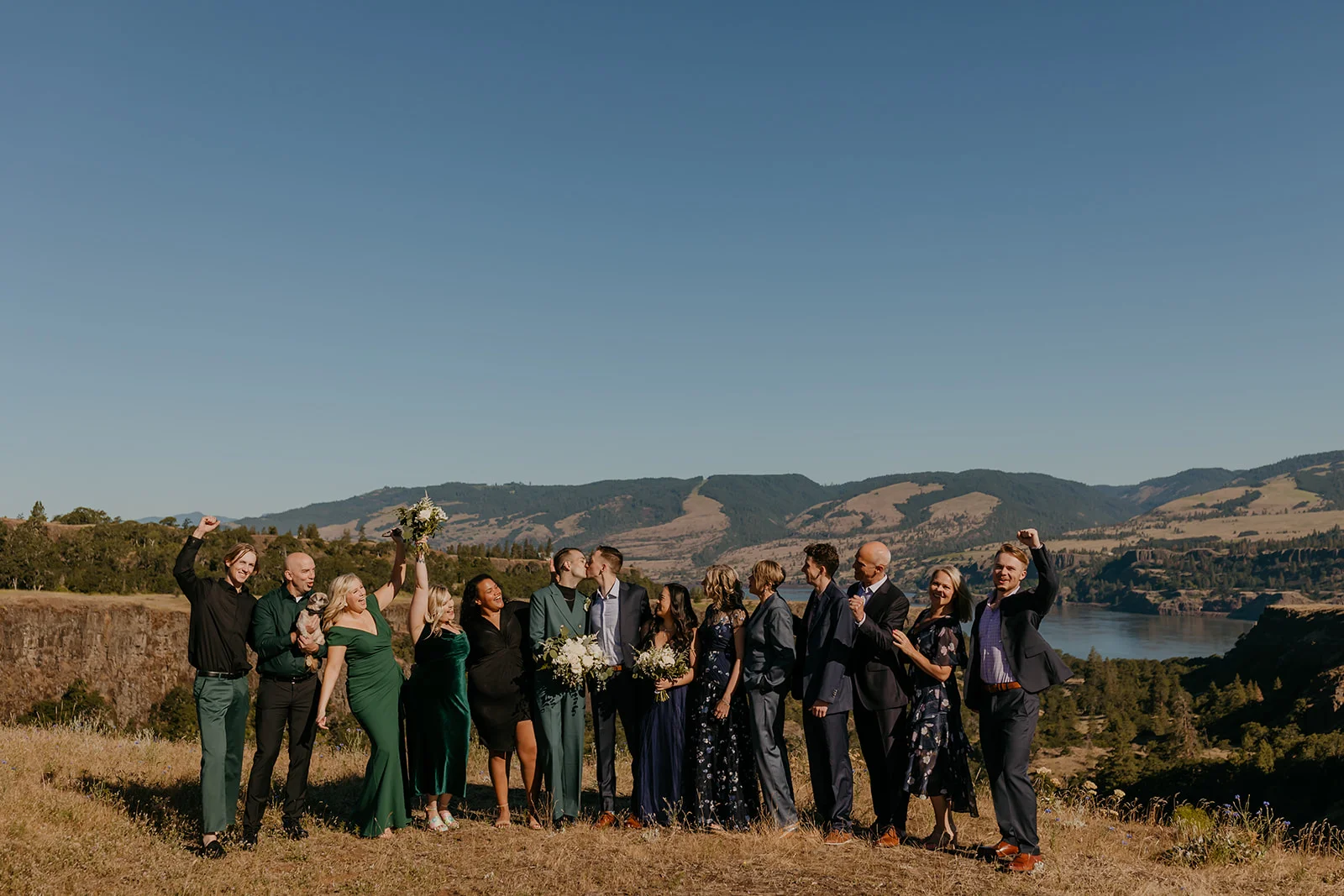 Ben and Nolan share a first kiss surrounded by cheering wedding guests at Mayer State Park in Mosier, OR.
