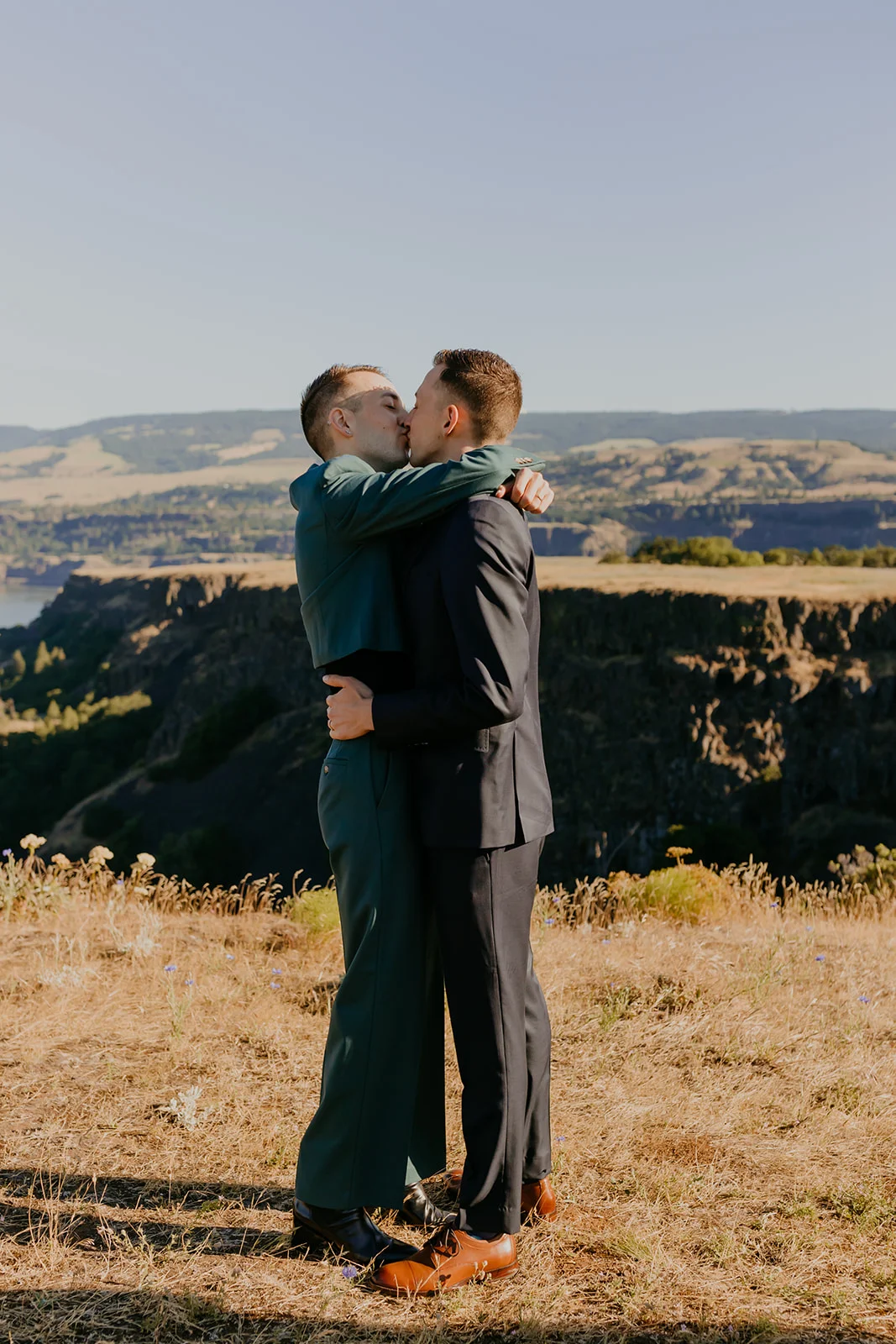 Ben and Nolan share their first kiss as newlyweds on a scenic cliff overlooking the Columbia River at Mayer State Park.