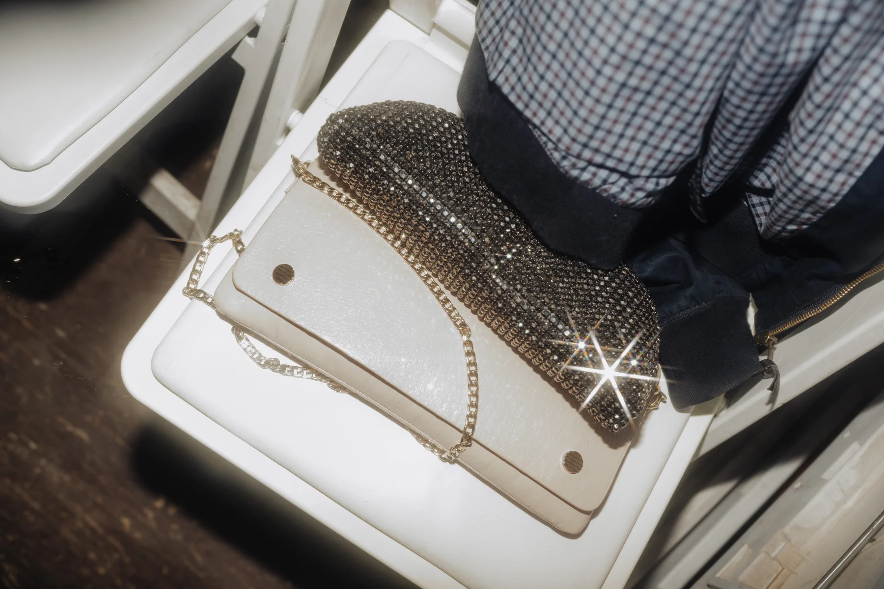 A crystal-encrusted shoe rests atop a white chain-strap clutch purse at The Hillside Lodge in Golden, BC.