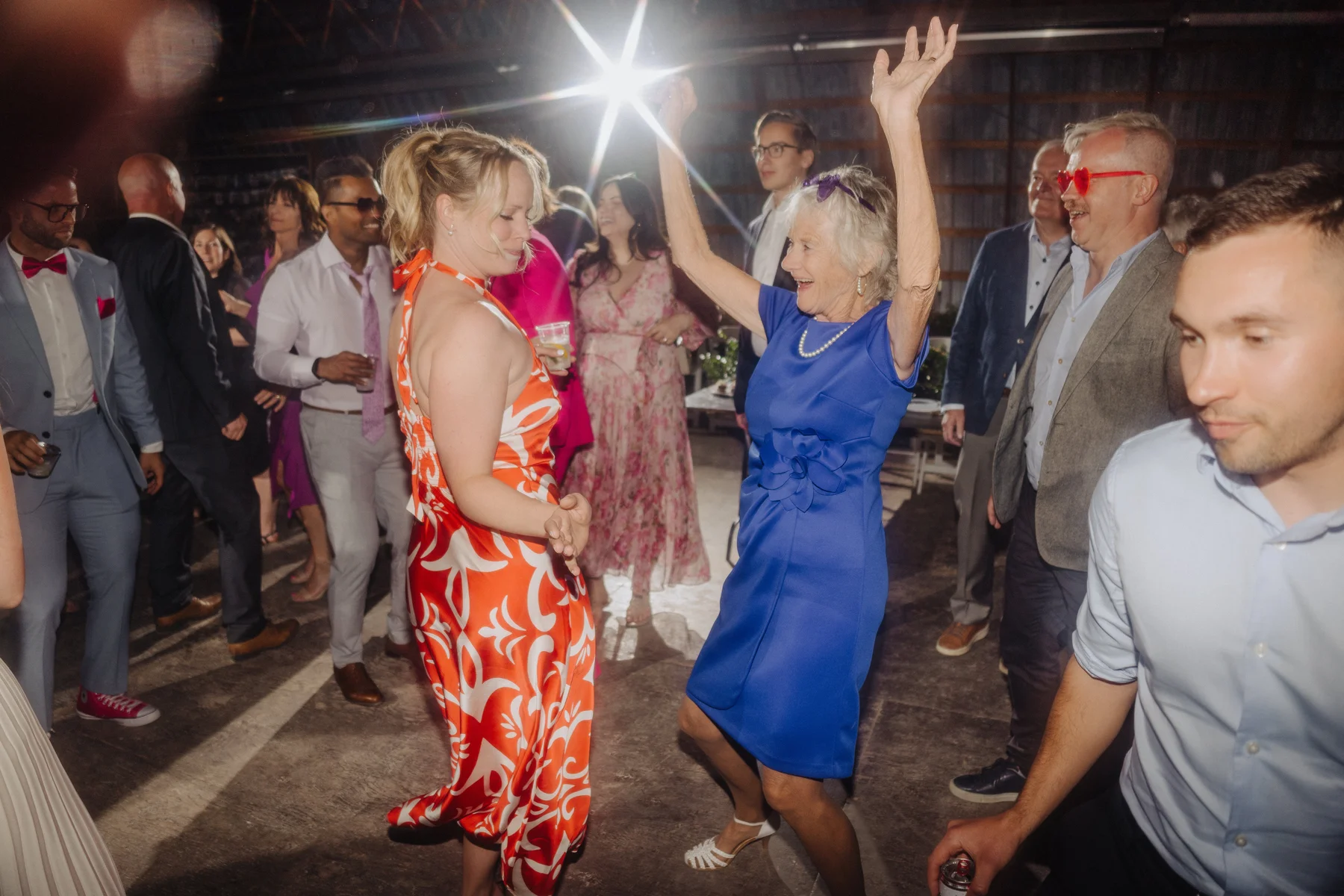 Guests dance joyfully at Trent and Cameron Harris-McCoy's wedding reception at The Hillside Lodge in Golden, BC.