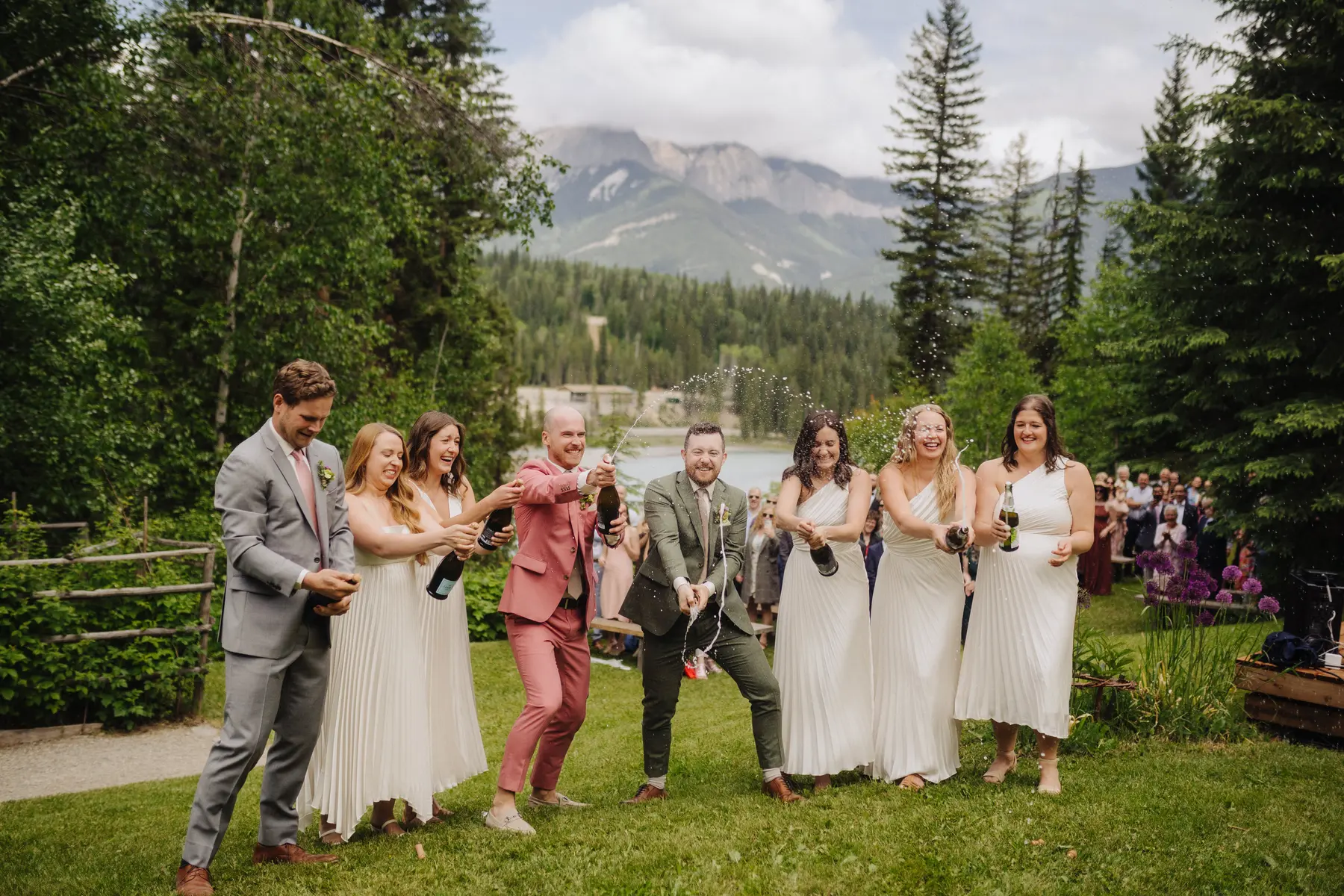 Trent and Cameron Harris-McCoy pop champagne with their wedding party at The Hillside Lodge & Chalets in Golden, BC, Canada.