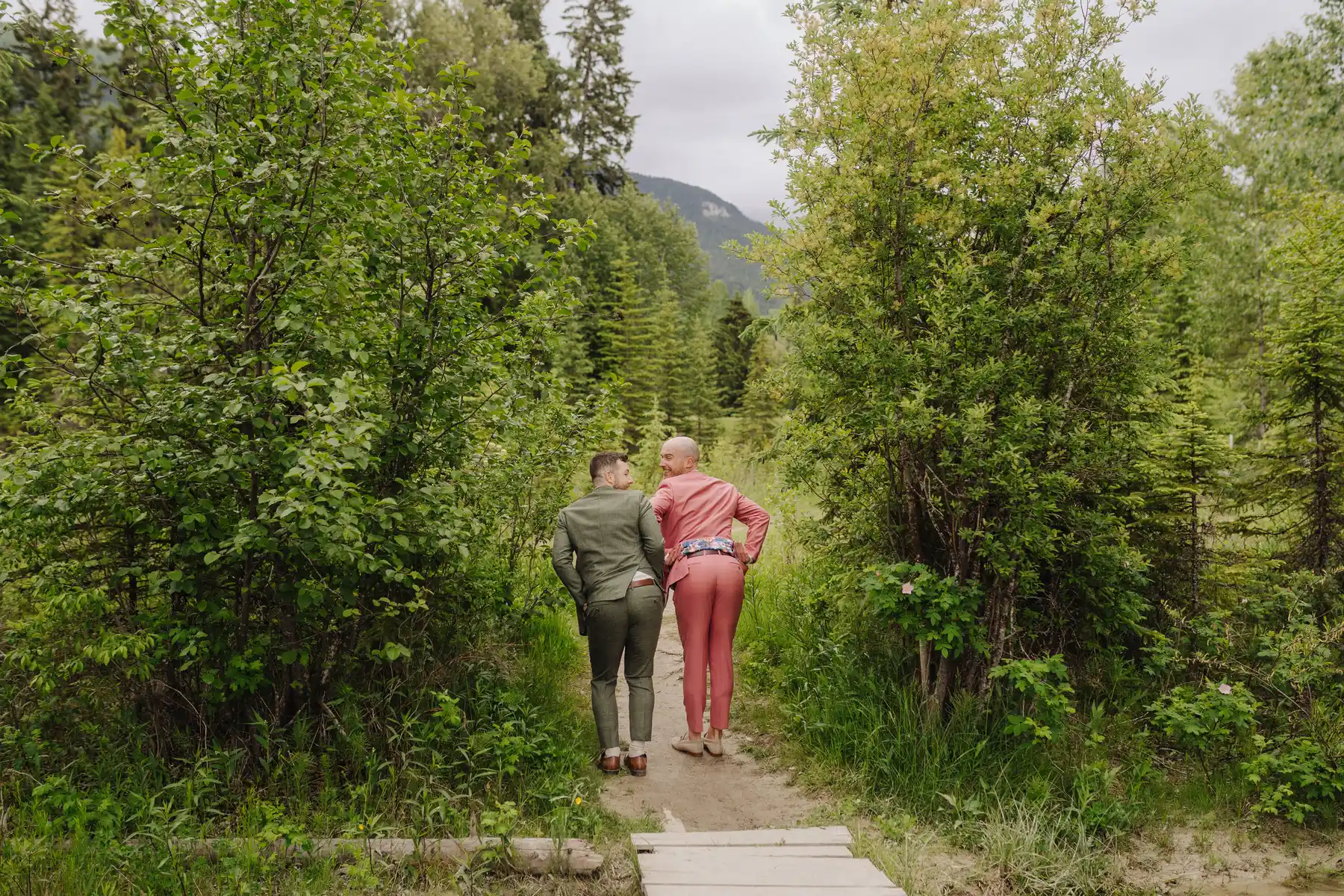 Trent and Cameron Harris-McCoy walk hand in hand down a forest trail at The Hillside Lodge & Chalets in Golden, BC.