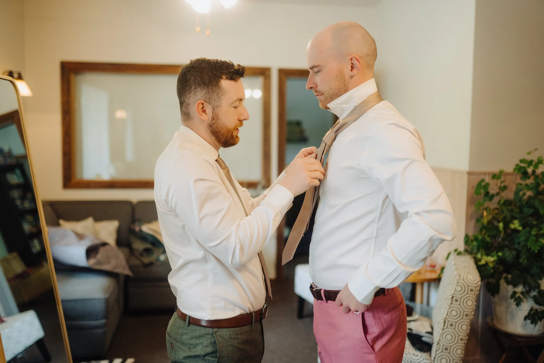Trent helps Cameron adjust his tie while getting ready at The Hillside Lodge & Chalets in Golden, BC.