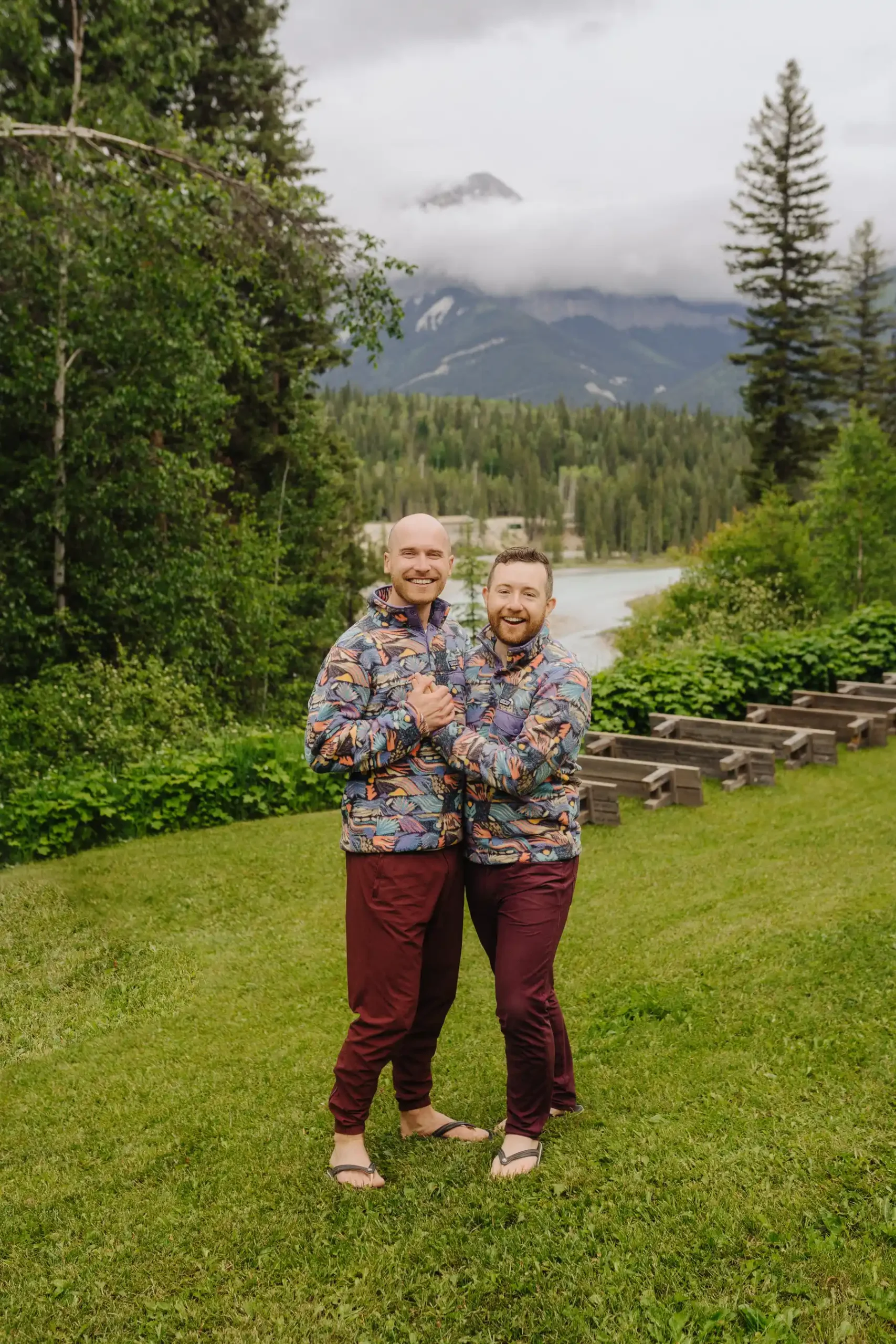 Trent and Cameron Harris-McCoy laugh together in matching patterned pullovers at The Hillside Lodge & Chalets in Golden, BC.