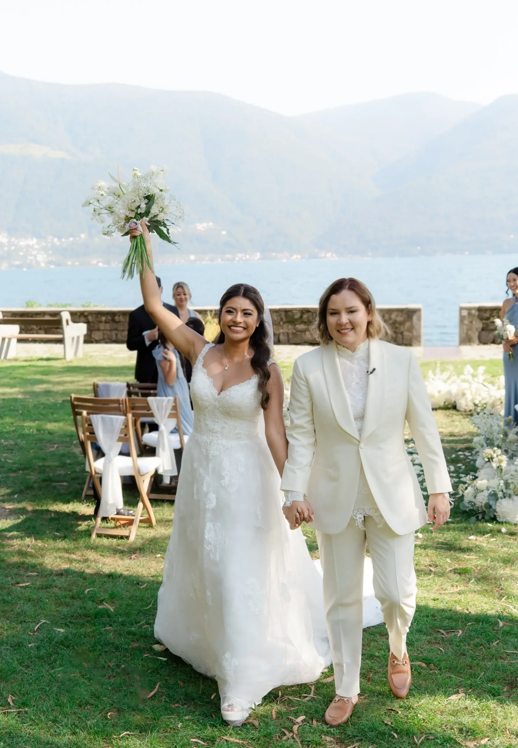 Ashley and Dionne walk hand-in-hand after their ceremony at Villa Emden on Brissago Island, Switzerland.