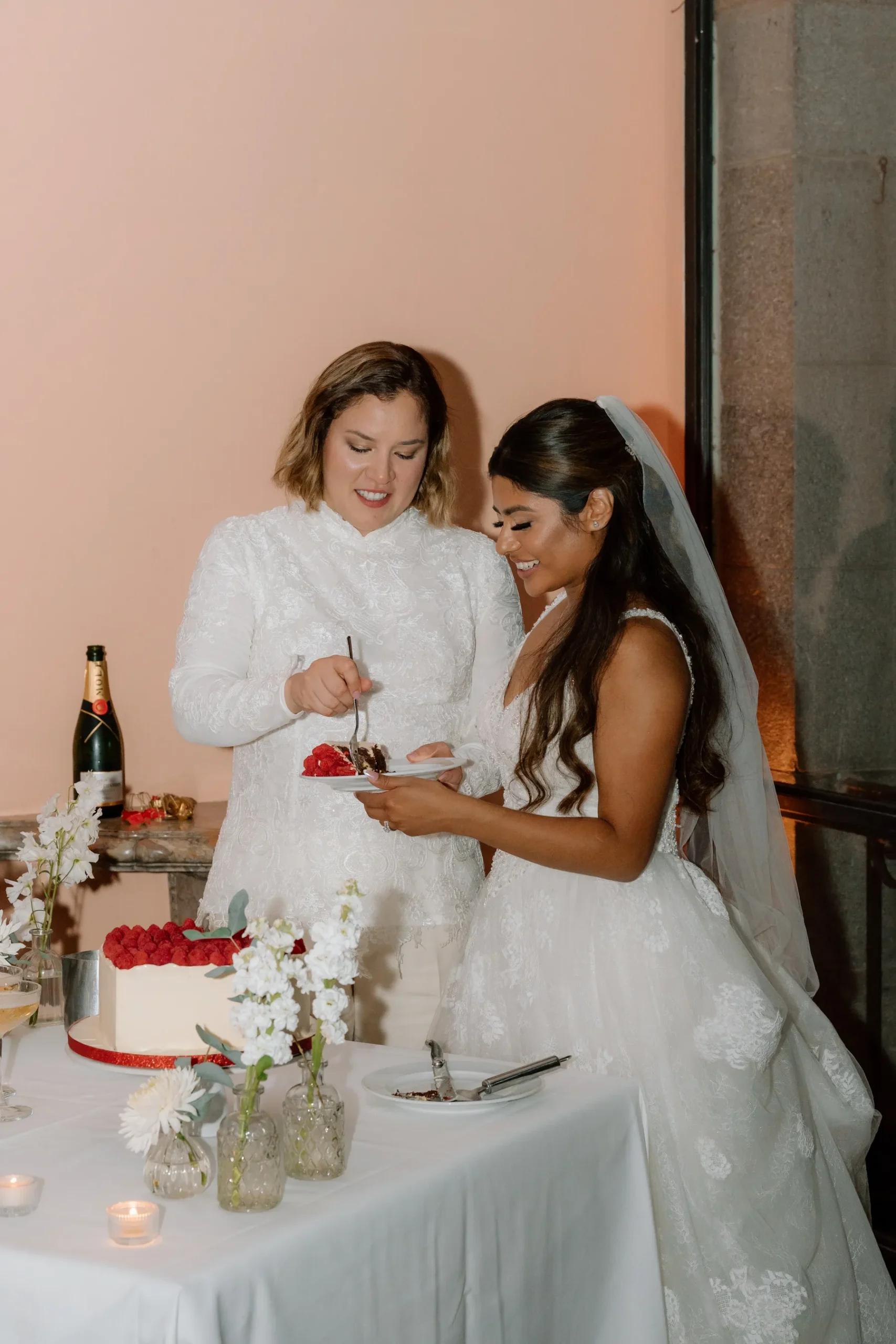 Ashley Rodriguez-Vargas and Dionne Vargas cut their wedding cake at Villa Emden on Brissago Island, Switzerland.