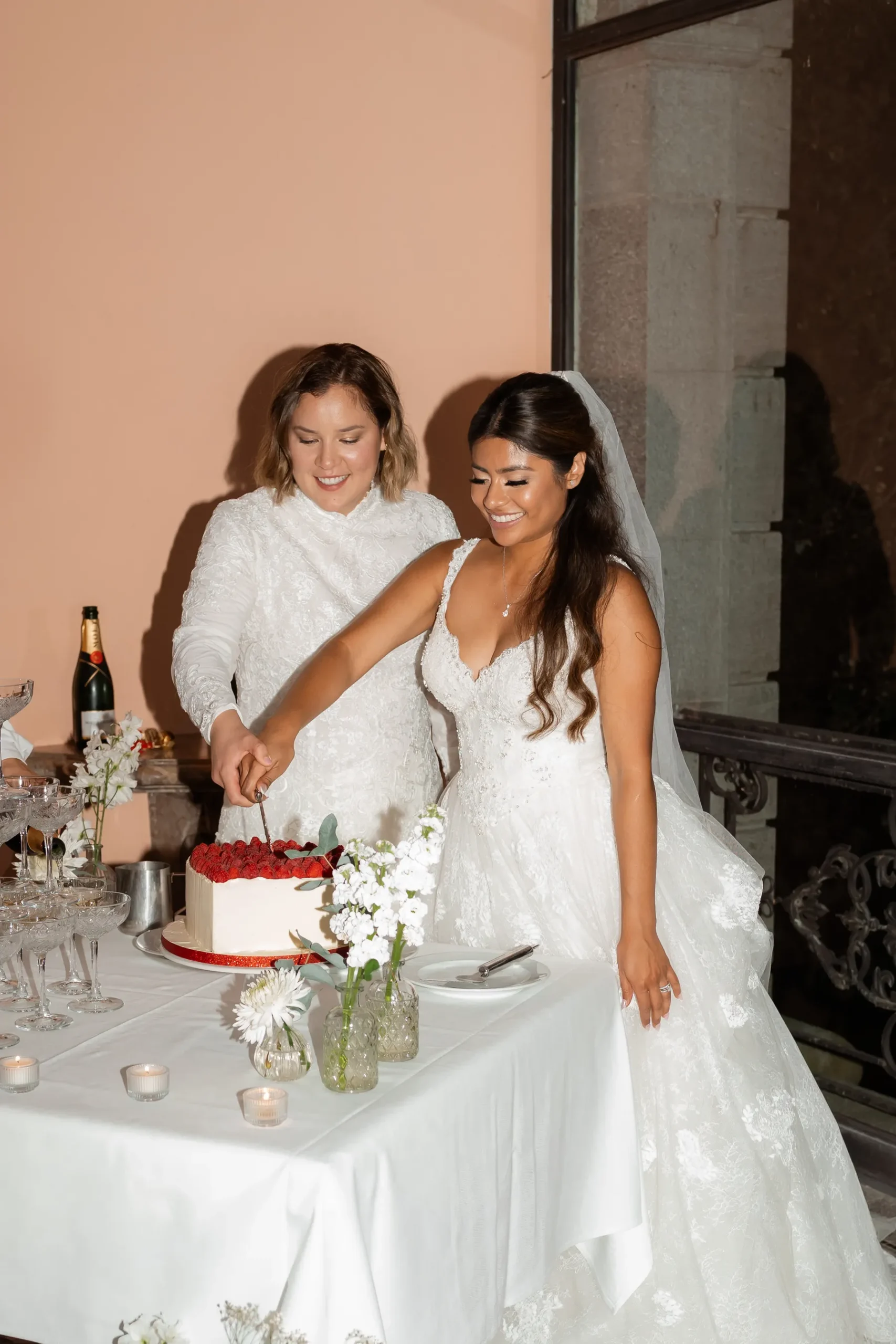 Ashley Rodriguez-Vargas and Dionne Vargas cut their wedding cake at Villa Emden on Brissago Island, Switzerland.