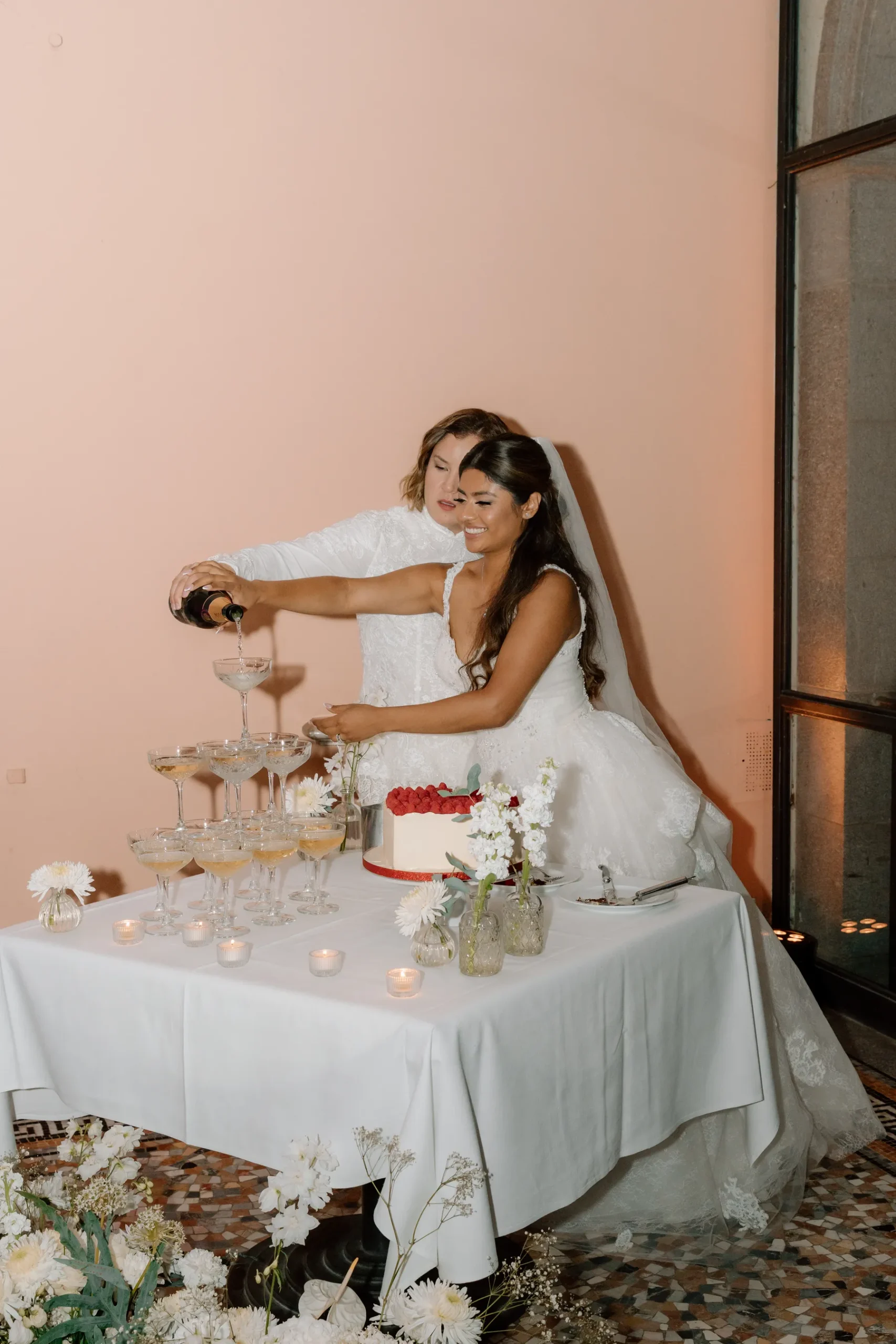 Ashley Rodriguez-Vargas and Dionne Vargas pour champagne tower at their wedding reception at Villa Emden on Brissago Island, Switzerland.
