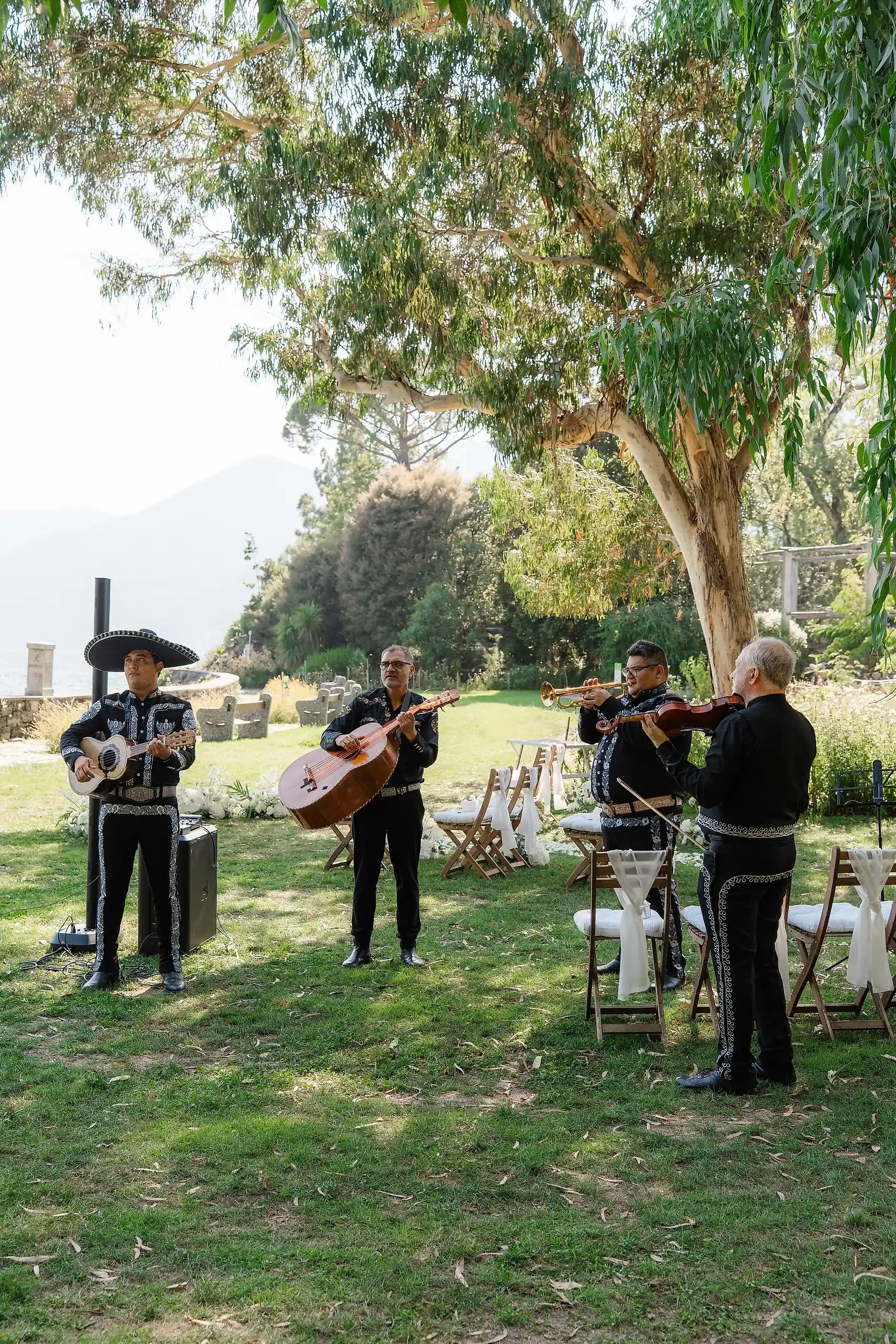 A mariachi band performs outdoors at Villa Emden on Brissago Island, Switzerland, at Ashley Rodriguez-Vargas and Dionne Vargas's wedding.