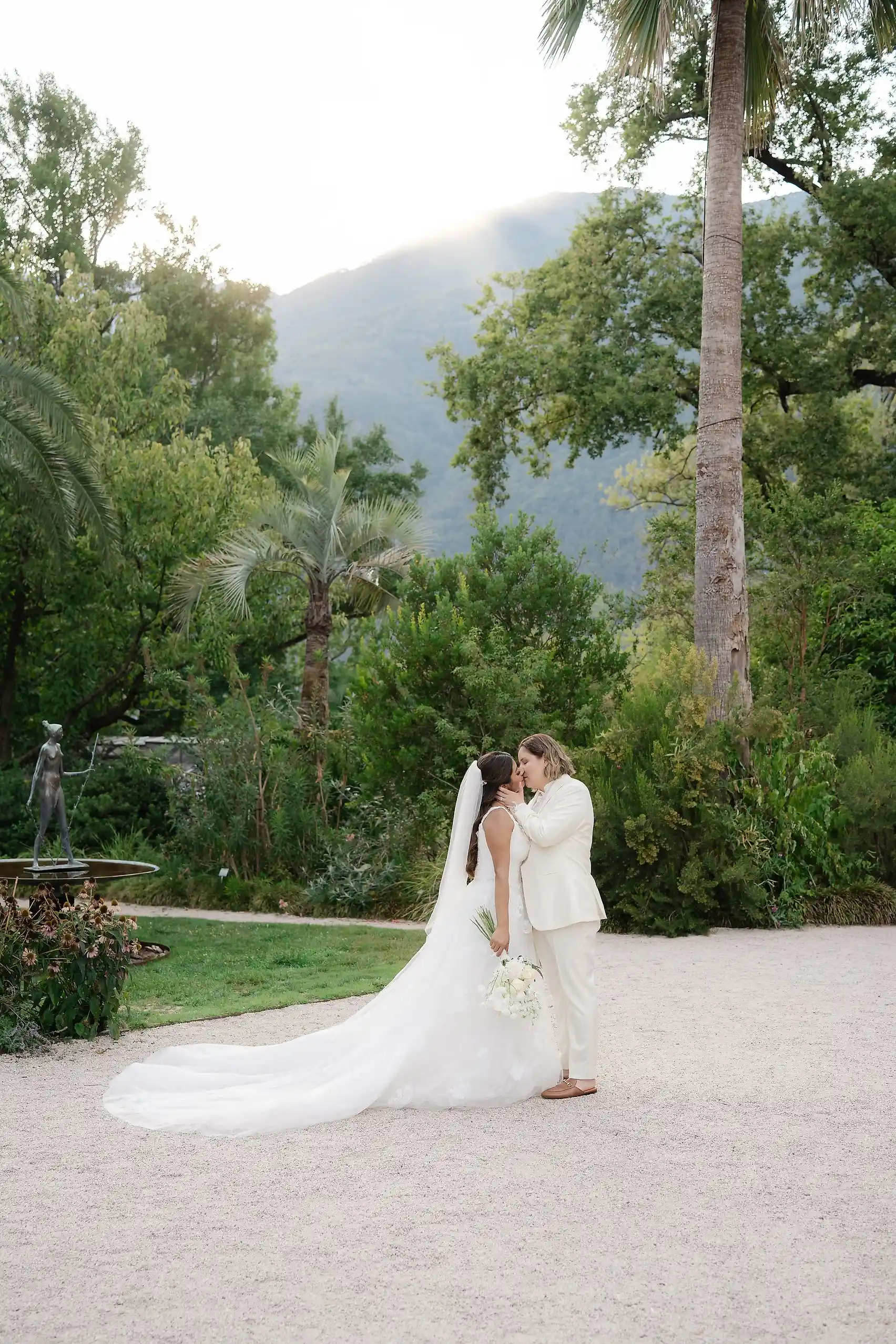Ashley Rodriguez-Vargas and Dionne Vargas share a kiss in the garden at Villa Emden on Brissago Island, Switzerland.