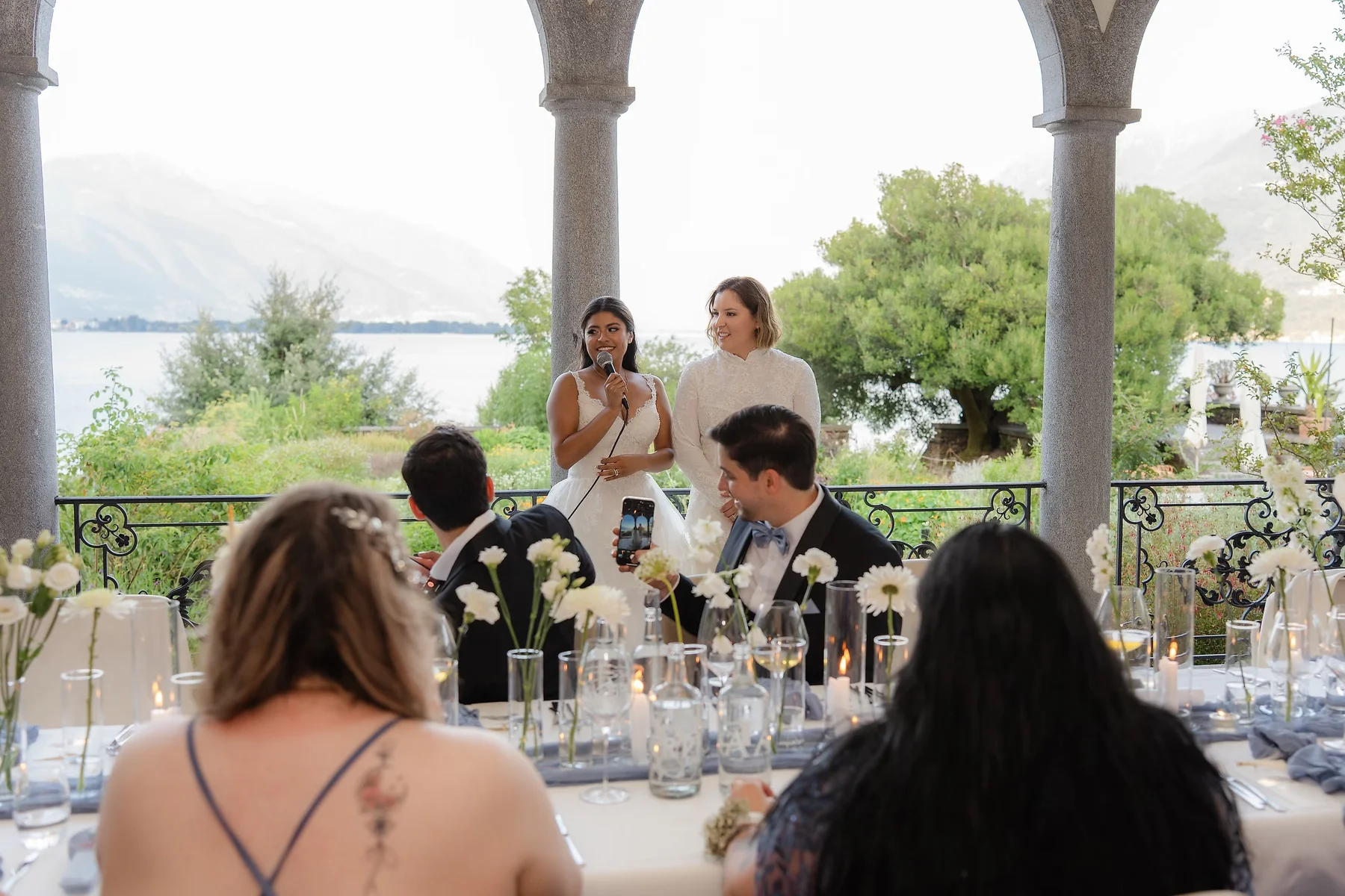 Ashley Rodriguez-Vargas and Dionne Vargas give a toast at their wedding reception at Villa Emden on Brissago Island, Switzerland.