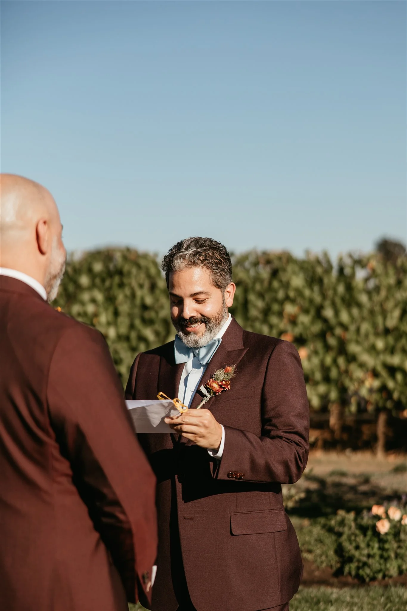 Josue Diaz smiles while reading wedding vows to Jonathan Snowden at Stoller Family Estate in Dayton, OR.