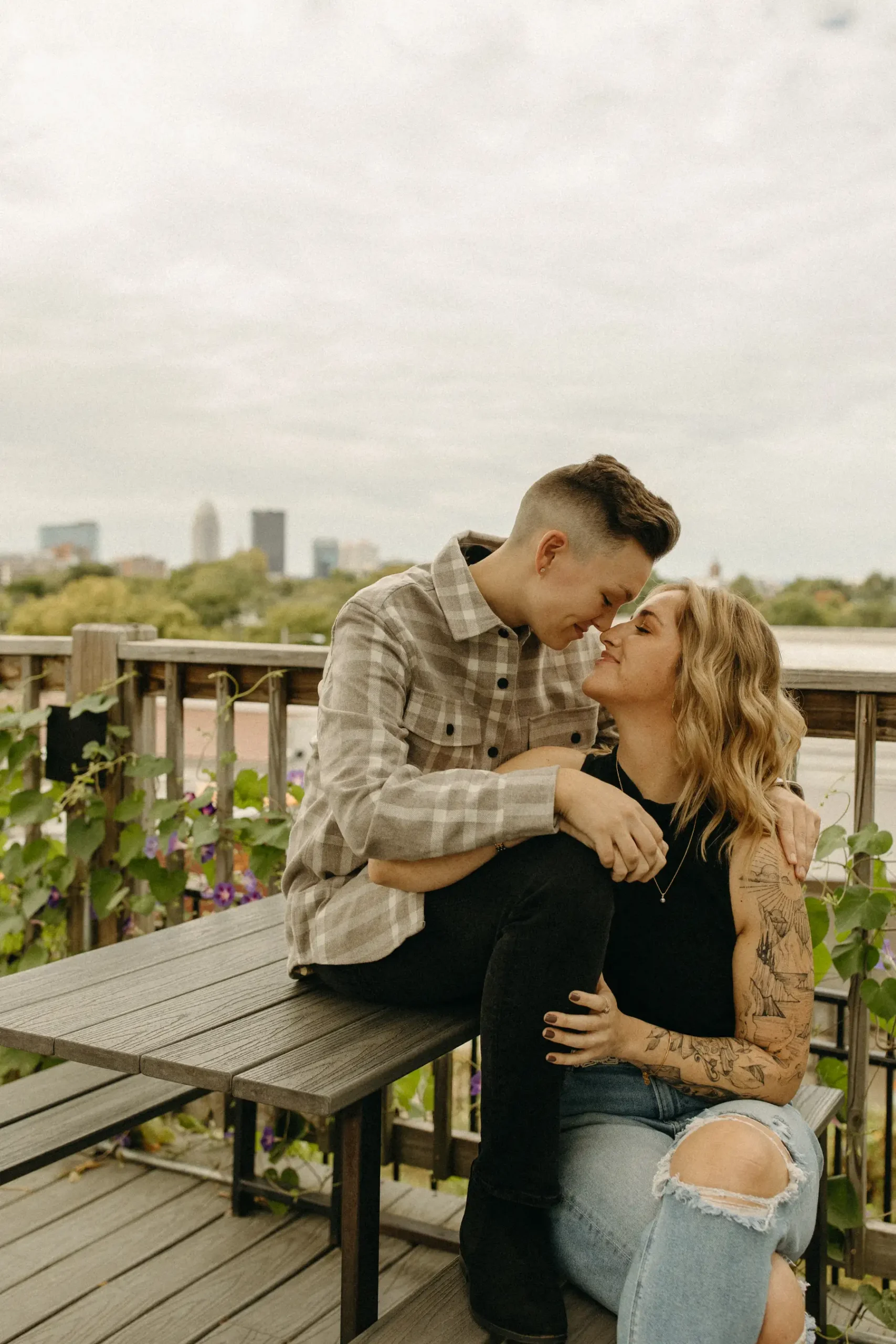 A couple shares an intimate almost-kiss on a rooftop deck at Gravely Brewing Co in Denver, Colorado.